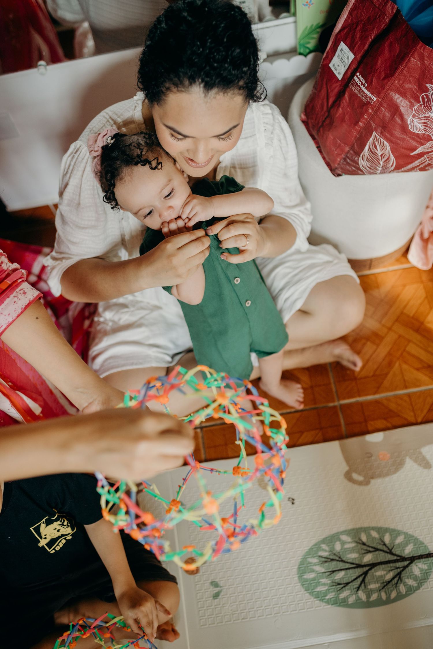A creative playtime session with colorful building toys on a patterned floor mat.