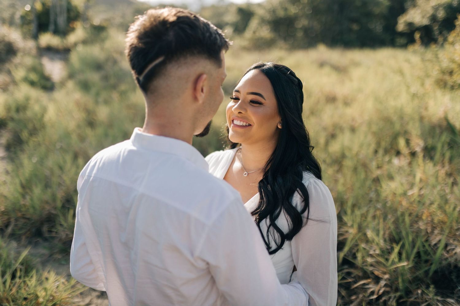 Loving couple poses together in nature during an outdoor portrait session.
