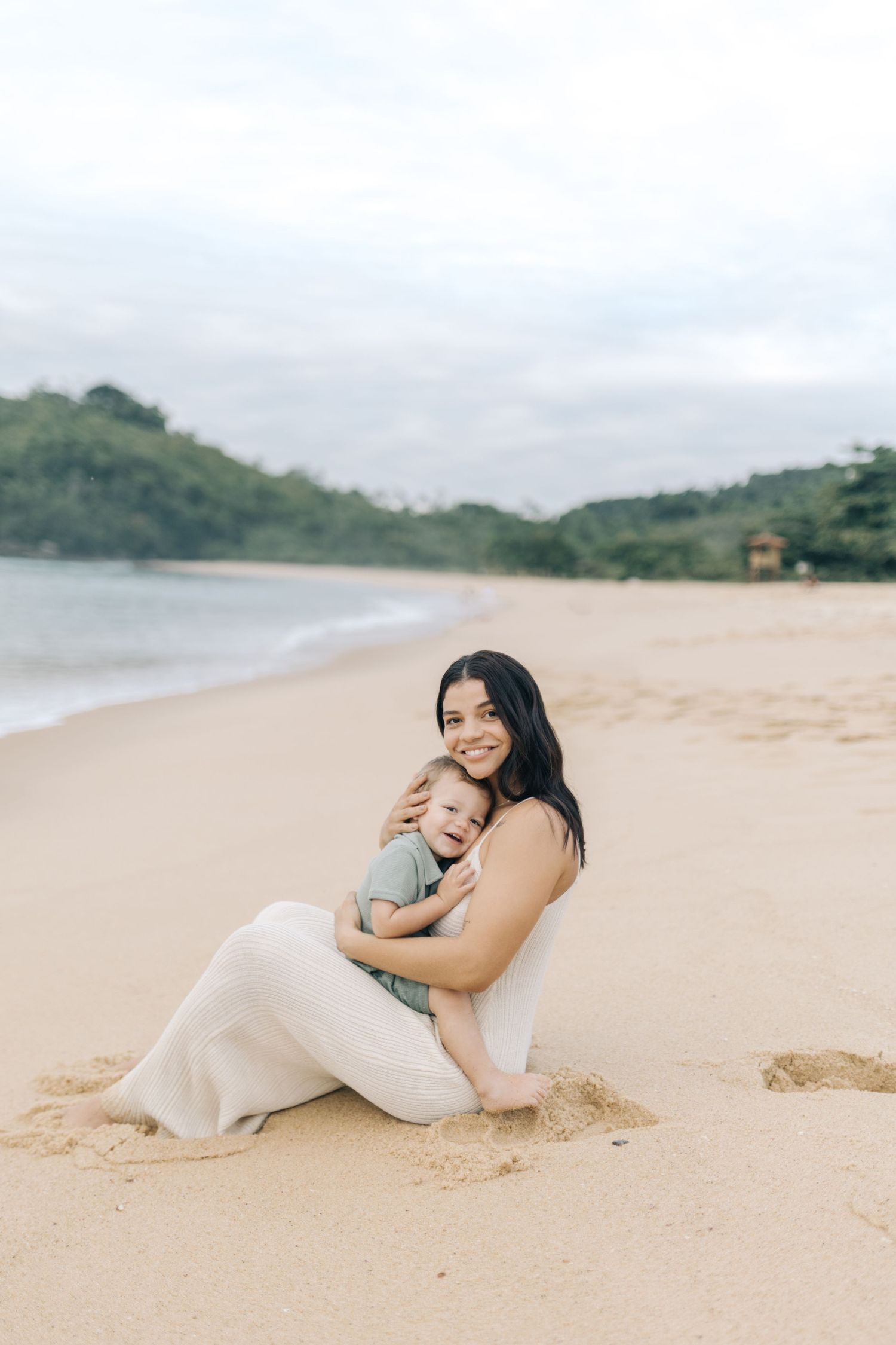 A tender family moment captured while lounging on a serene tropical beach.