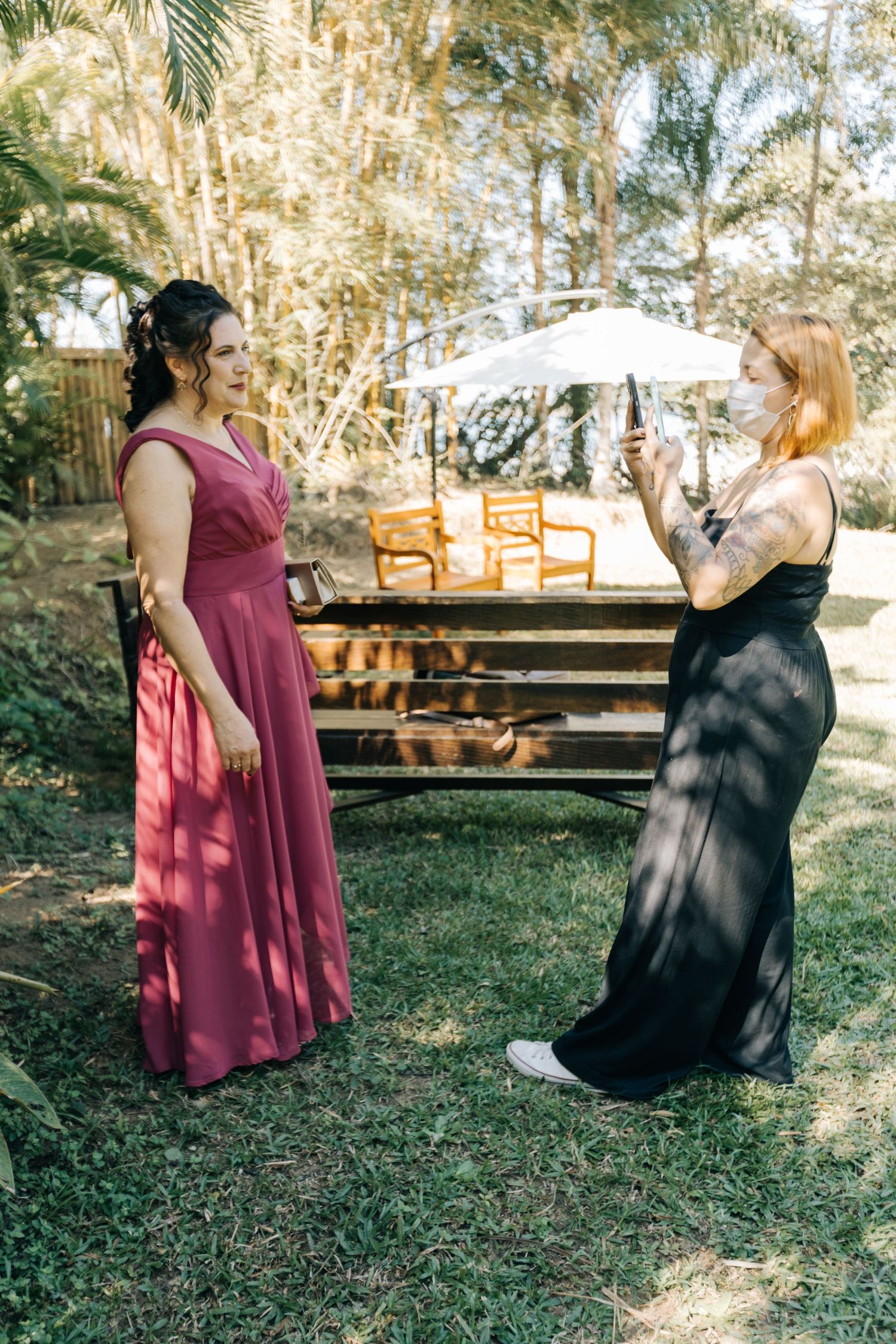 Wedding day photo session in a tropical garden setting with parasol.
