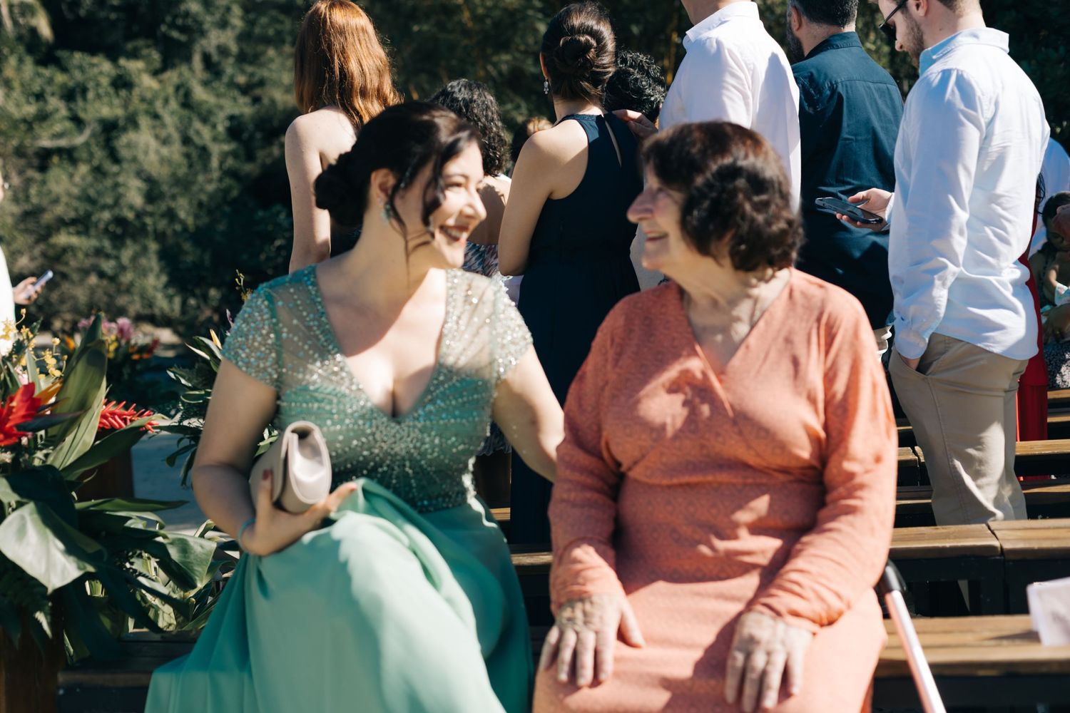 Wedding celebration with attendees in coordinated pastel colors mingling outdoors.