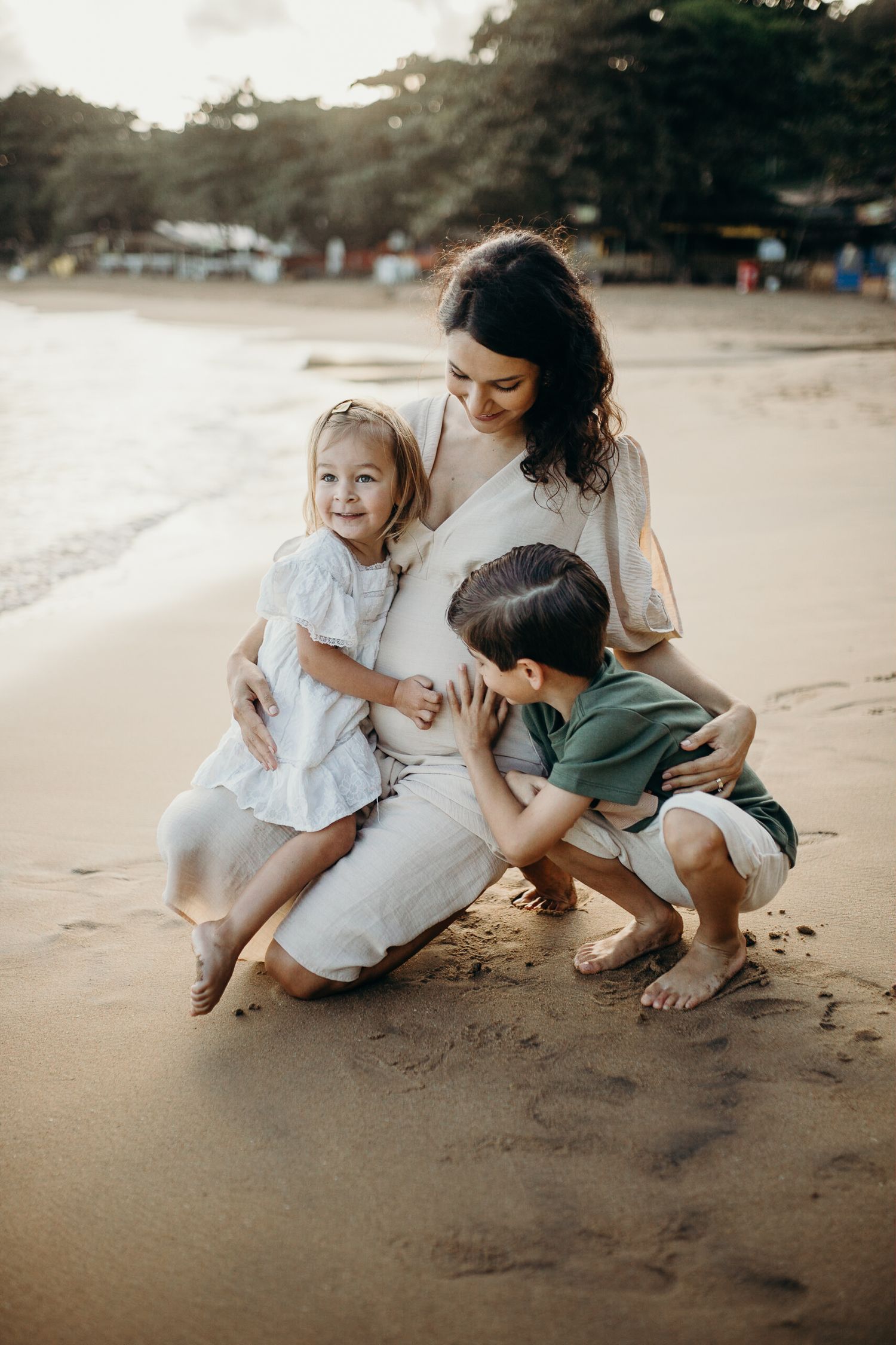 Sweet candid moment captured of family bonding on a beach.