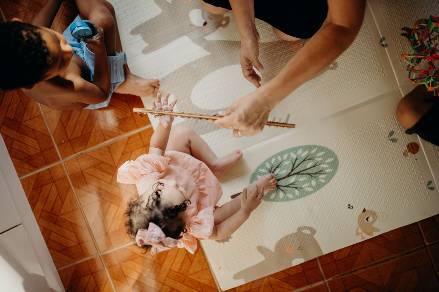 Group music session on decorative floor mat with kalimba and other instruments.