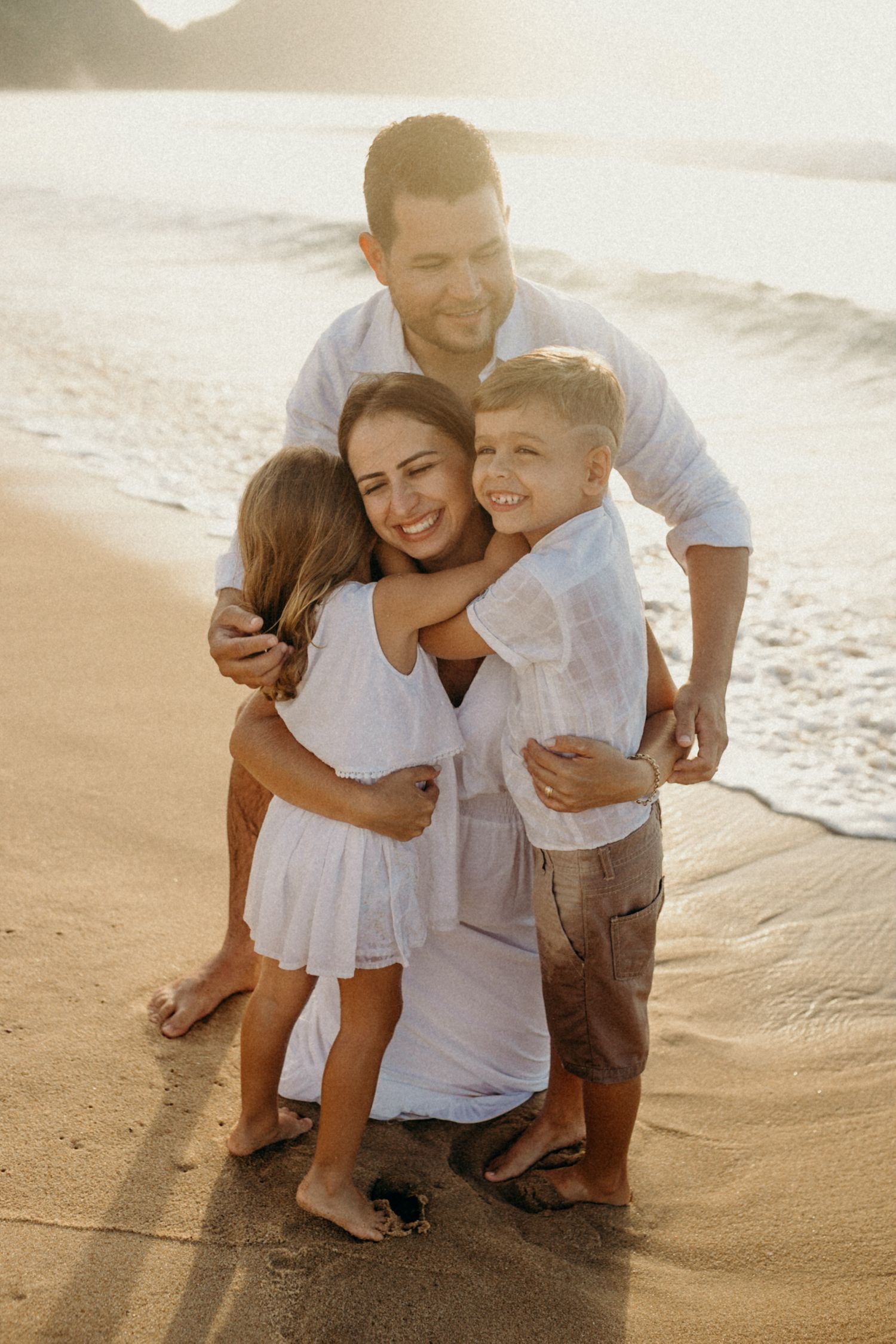 Heartwarming family moment captured on a sunlit beach.