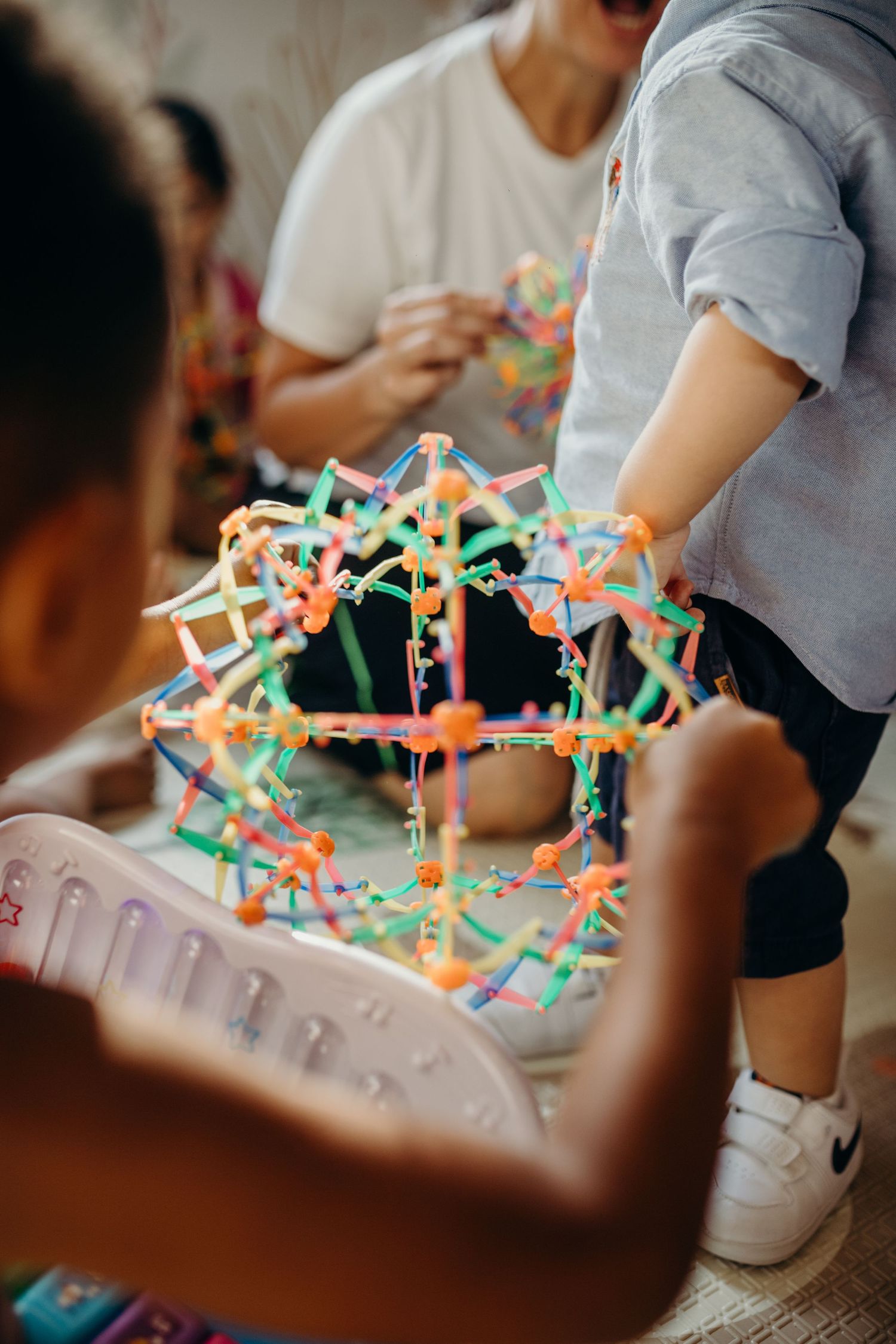 Colorful construction toys being assembled with bright connecting pieces on display.