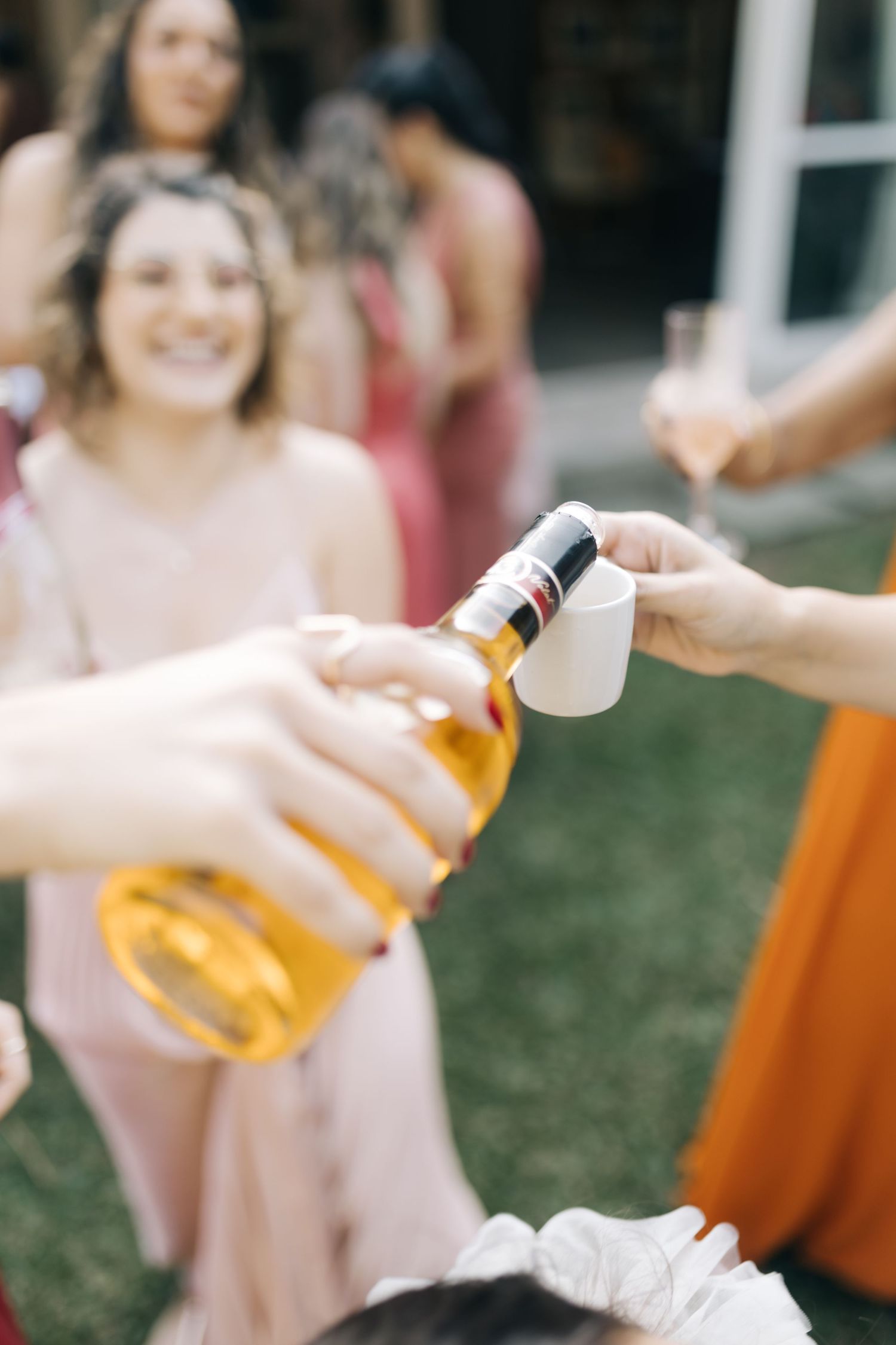 People holding beer bottles in casual celebration pose.