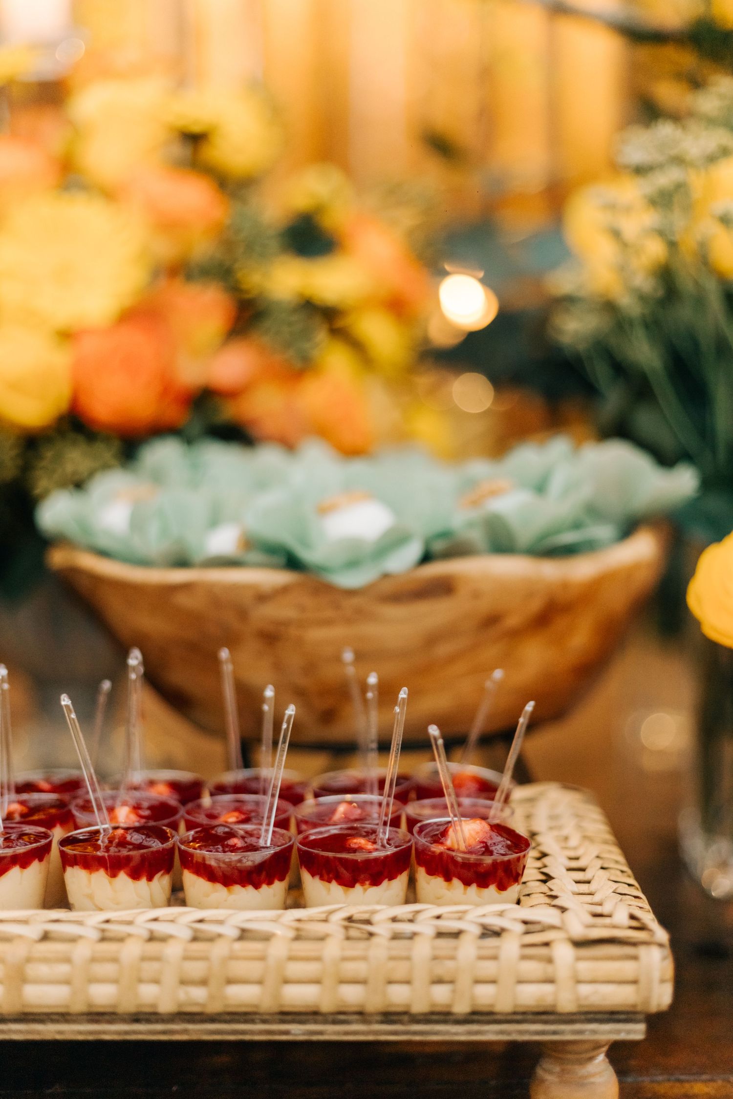 Elegant wedding dessert display featuring red jelly shots and decorative succulents.