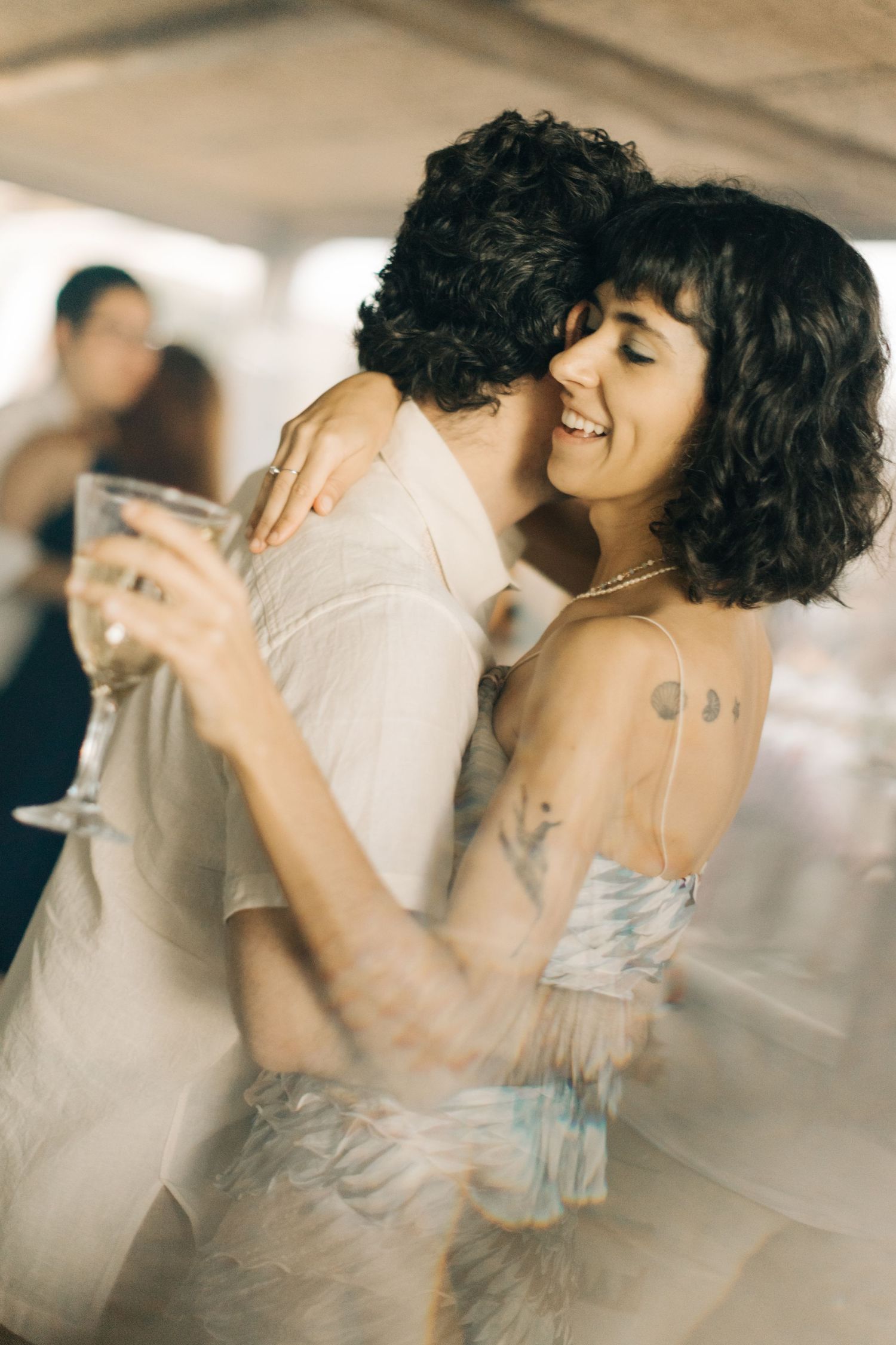 Partners sharing an intimate dance with joyful expressions.