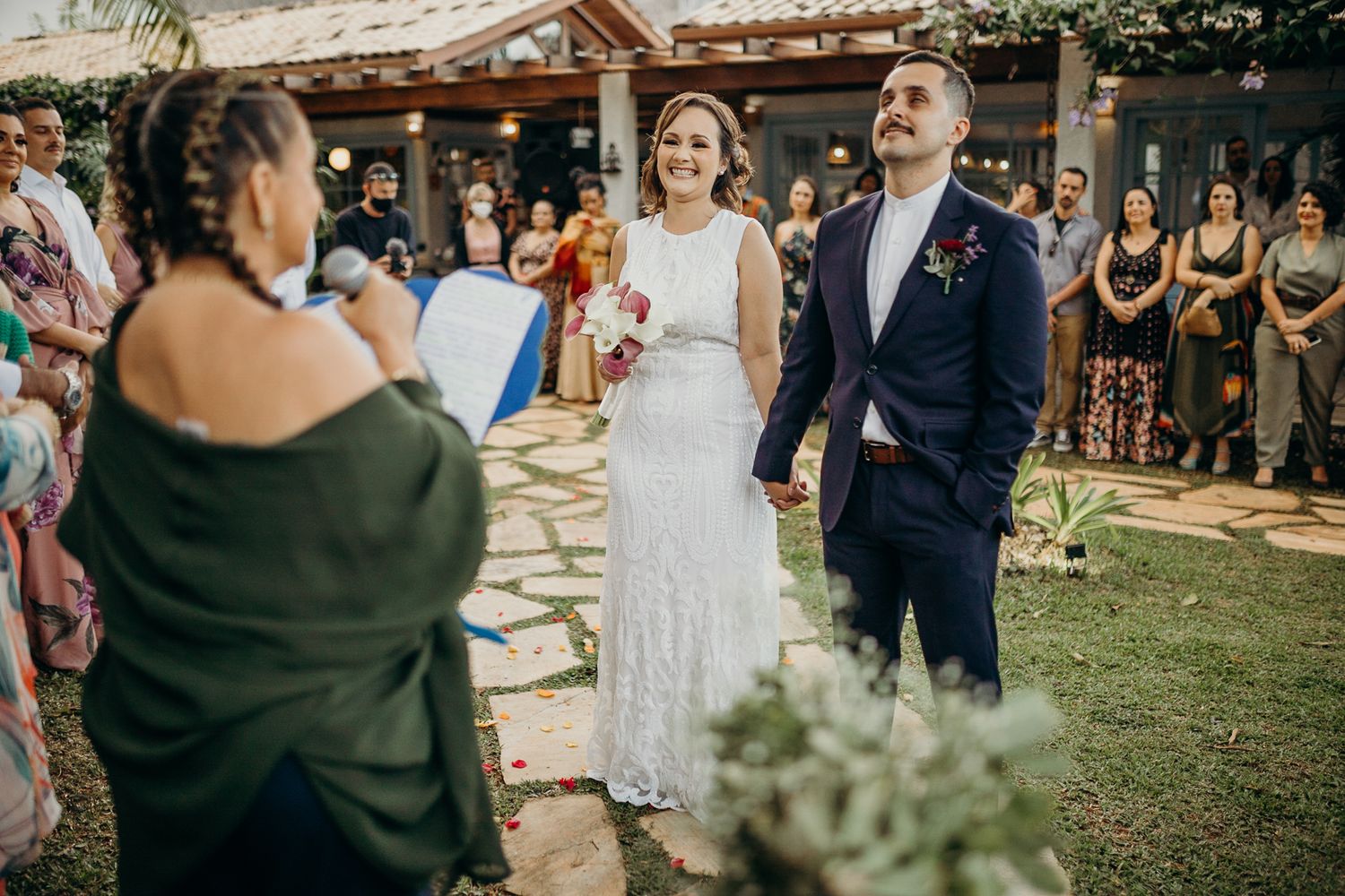 Wedding ceremony program with decorative rings placed on top in natural lighting.