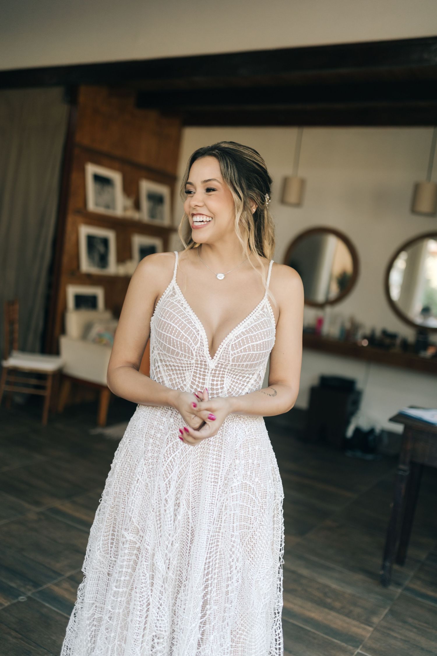 Flowing white lace dress captured in multiple angles against dark wooden flooring.