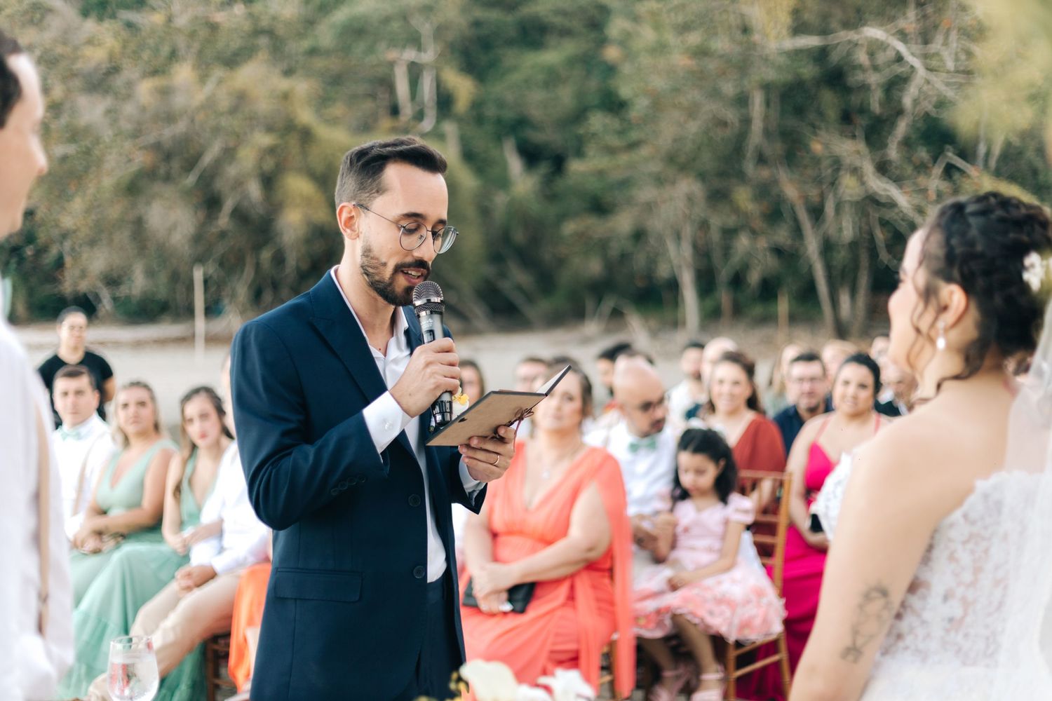 Candid moments during beach wedding ceremony with guests and officiant.