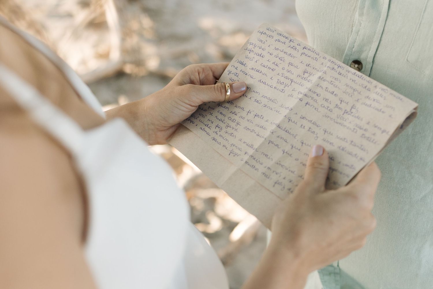 A close-up view of handwritten text on aged paper with soft lighting and a vintage aesthetic.