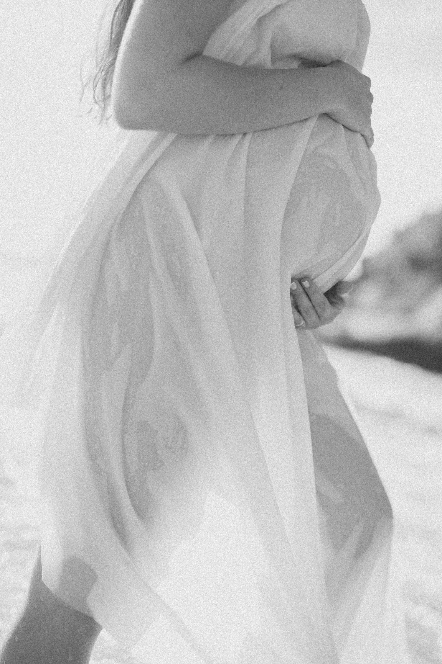 A dreamy black and white series showing elegant flowing white fabric in soft focus against a light background.