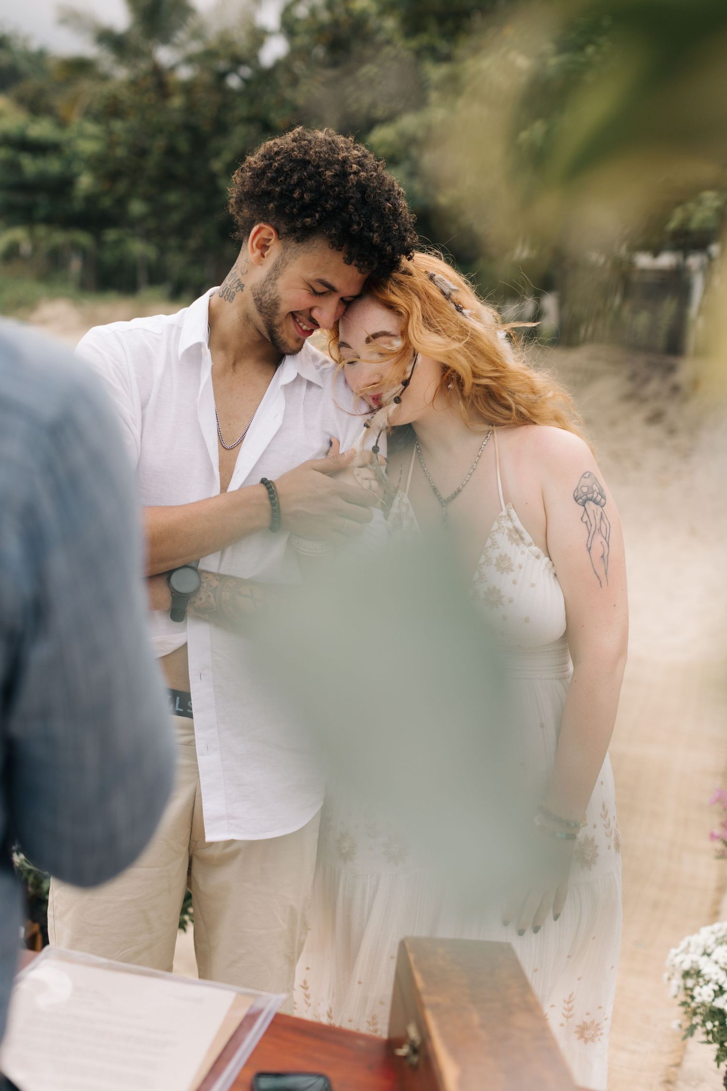 Emotional moment between newlyweds during their beach wedding ceremony.