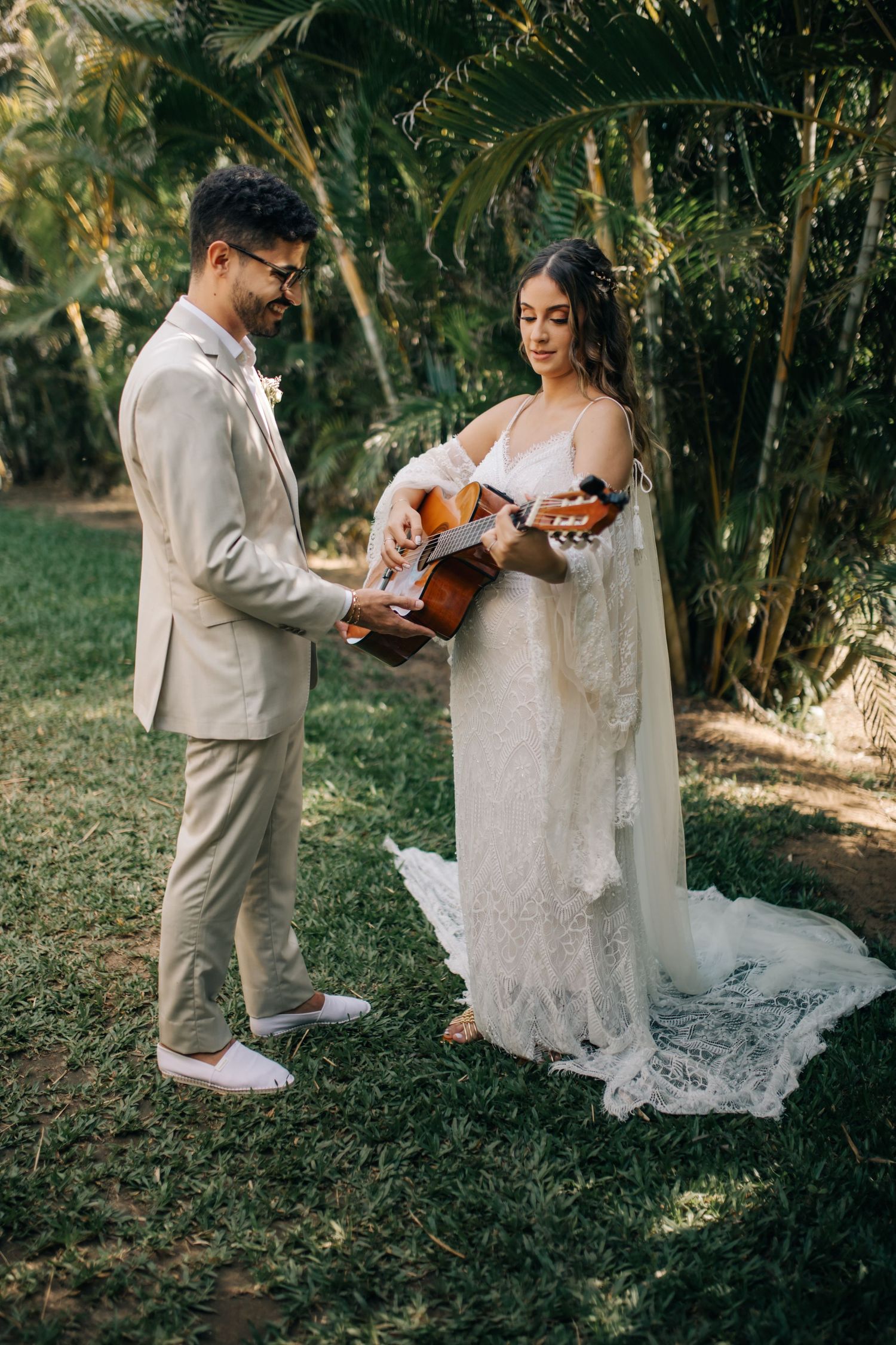 Couple with acoustic guitar at their outdoor wedding ceremony.