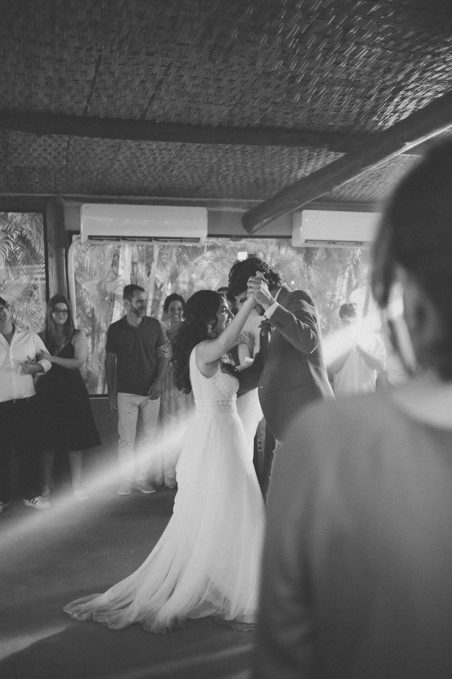 A couple shares a romantic dance together on their wedding day, twirling in an elegant ballroom setting.
