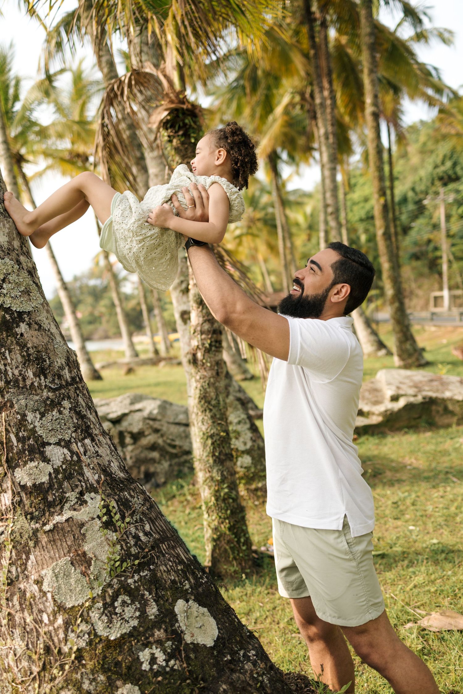 Person in white clothing climbing palm trees in a tropical setting with multiple action shots.