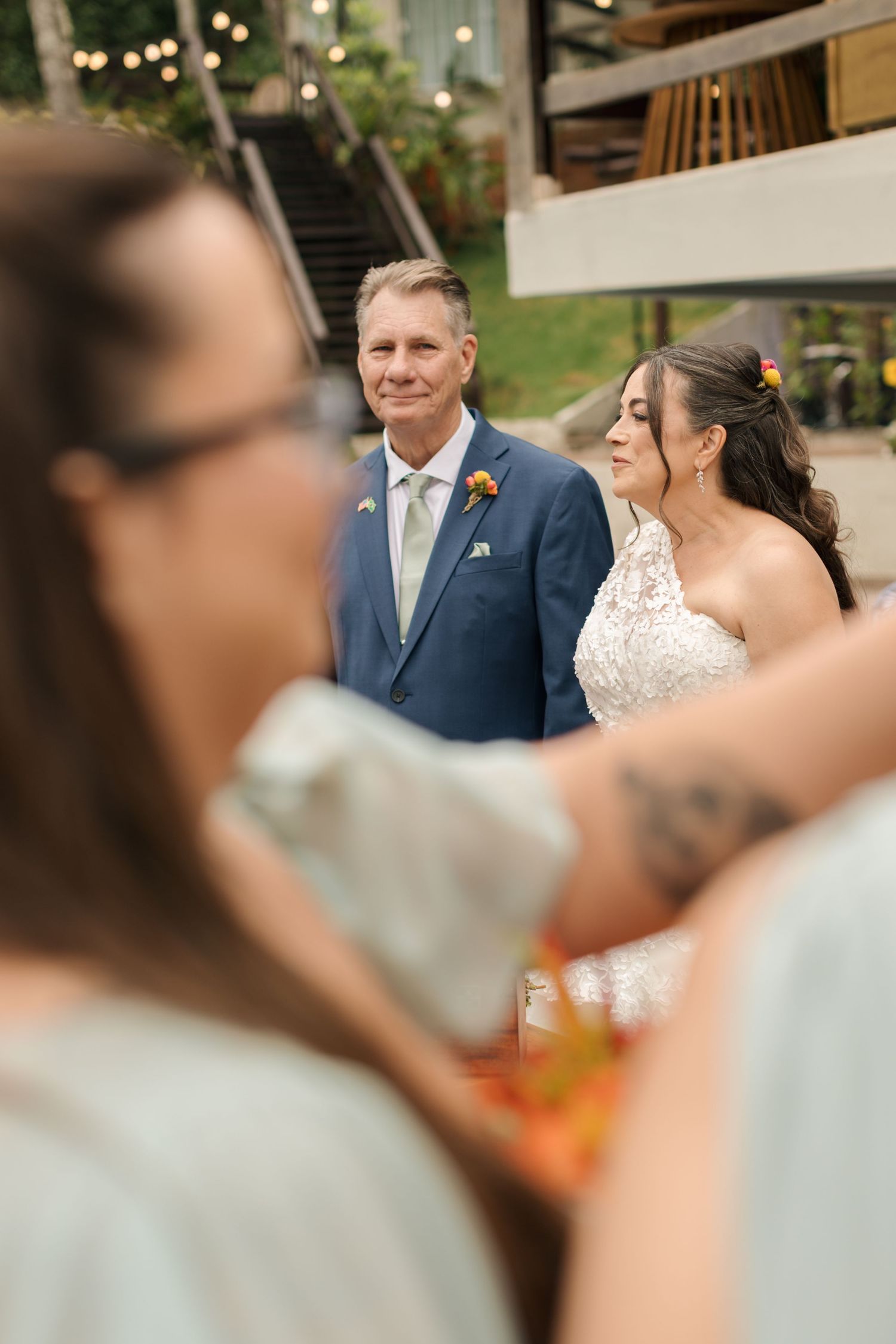 Wedding guests enjoying drinks and conversation at an outdoor reception.