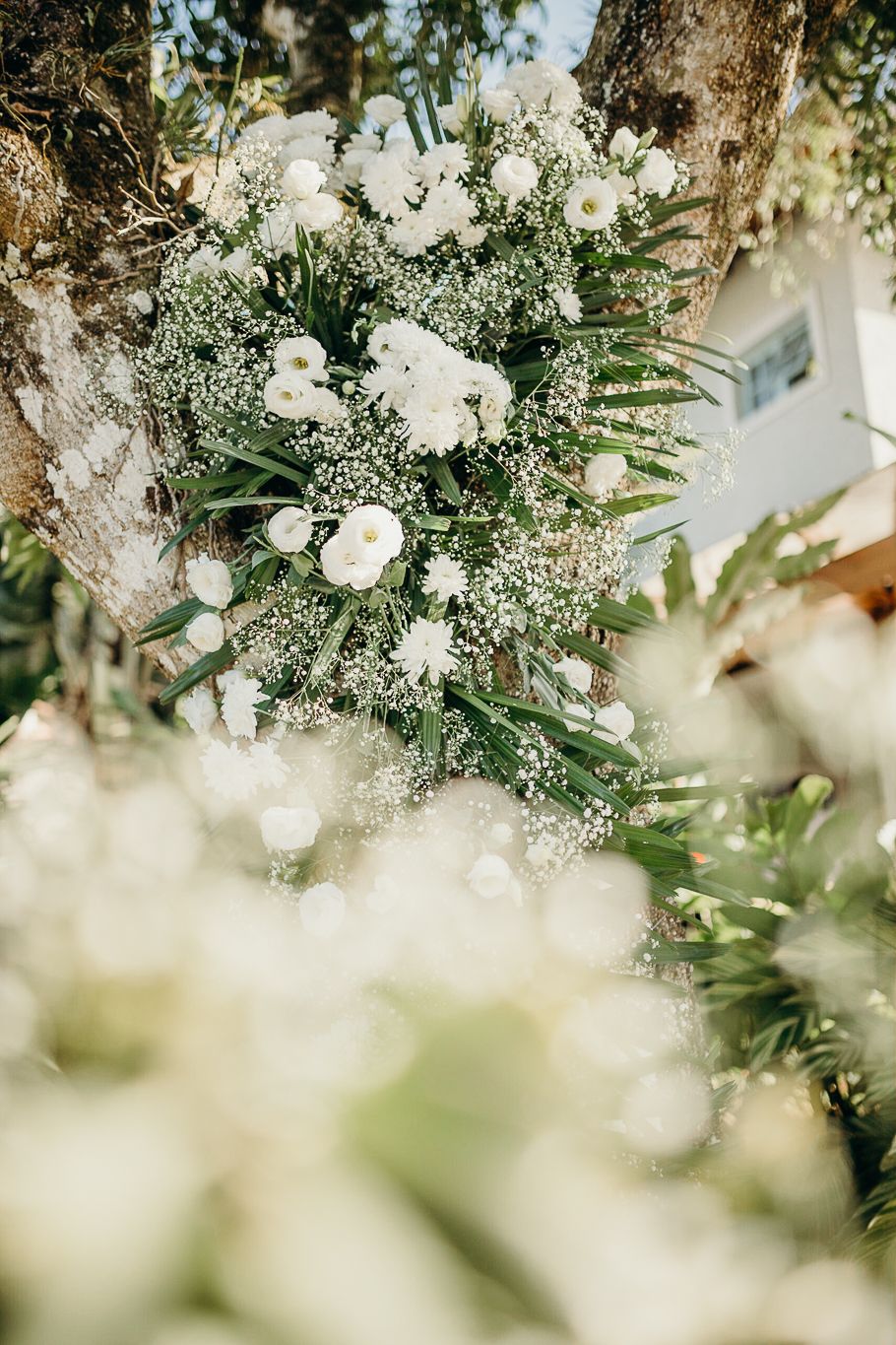 White floral arrangements with baby's breath create a dreamy overhead garden display.