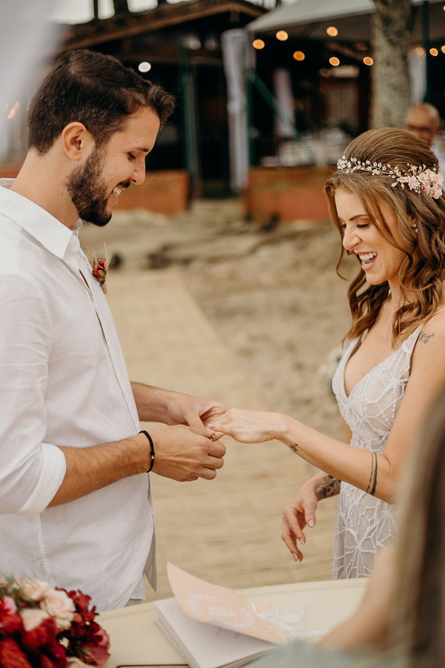 Sweet interaction between couple during intimate beach wedding ceremony.
