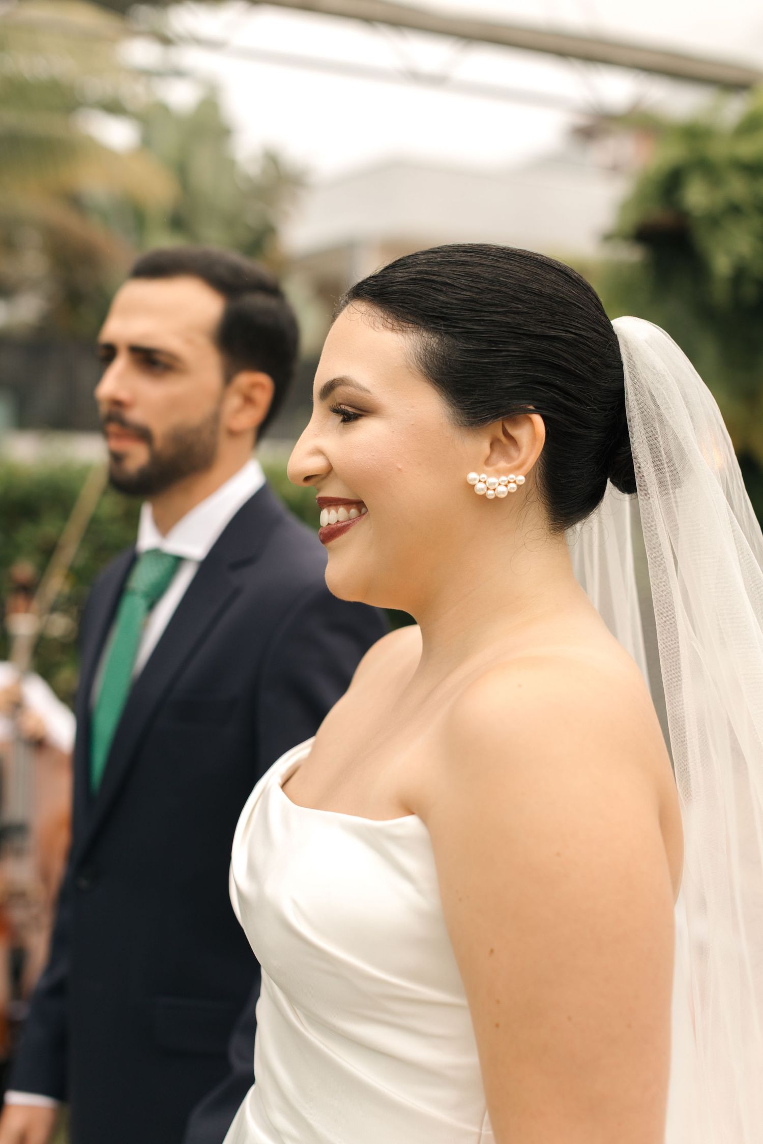 Candid expressions and laughter during a wedding ceremony with white and green color theme.