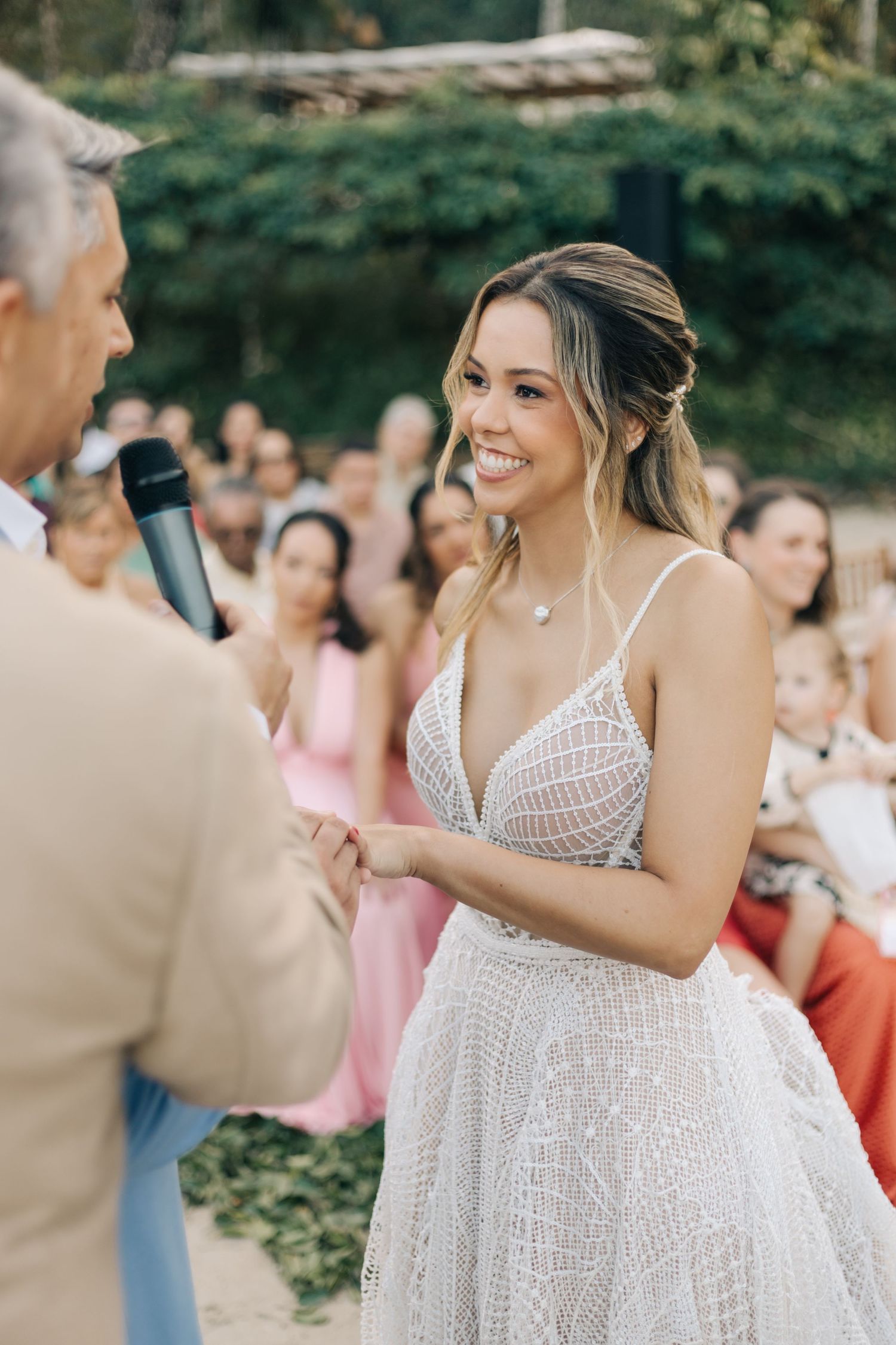 Joyful moments captured during a garden wedding ceremony with guests in attendance.
