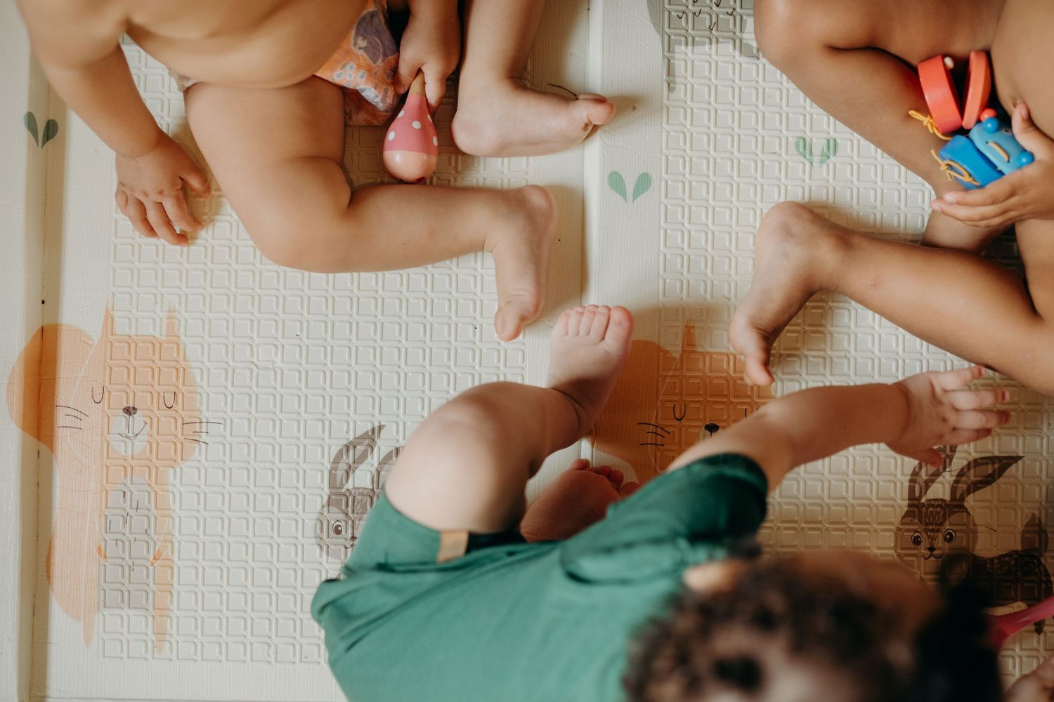 Overhead view of children participating in group activity on white floor.