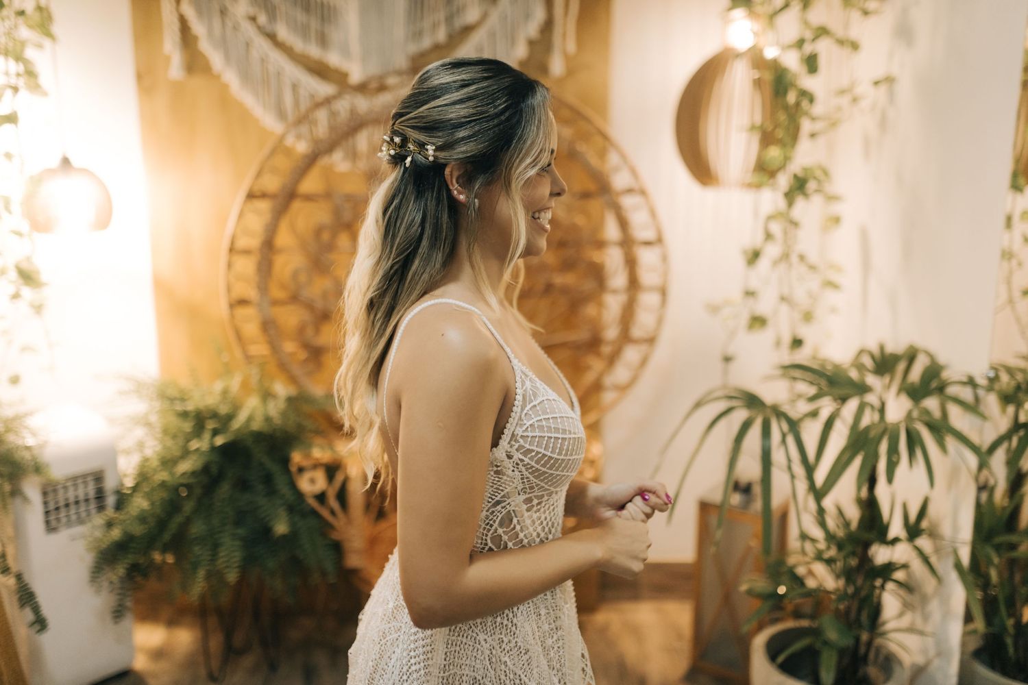 Interior venue space decorated with plants and warm lighting for special occasion.