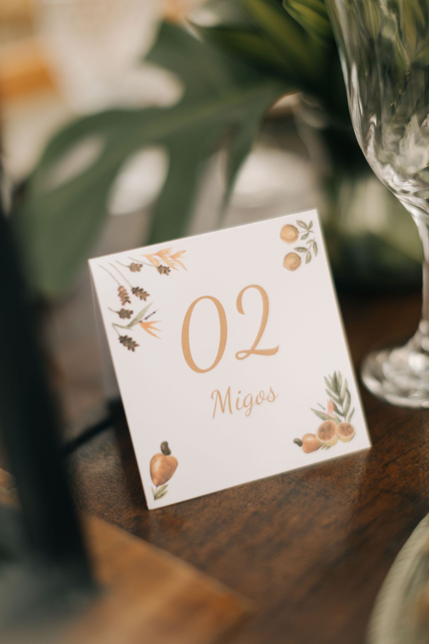 Elegant wedding table number card with floral design and number 02 in gold lettering.