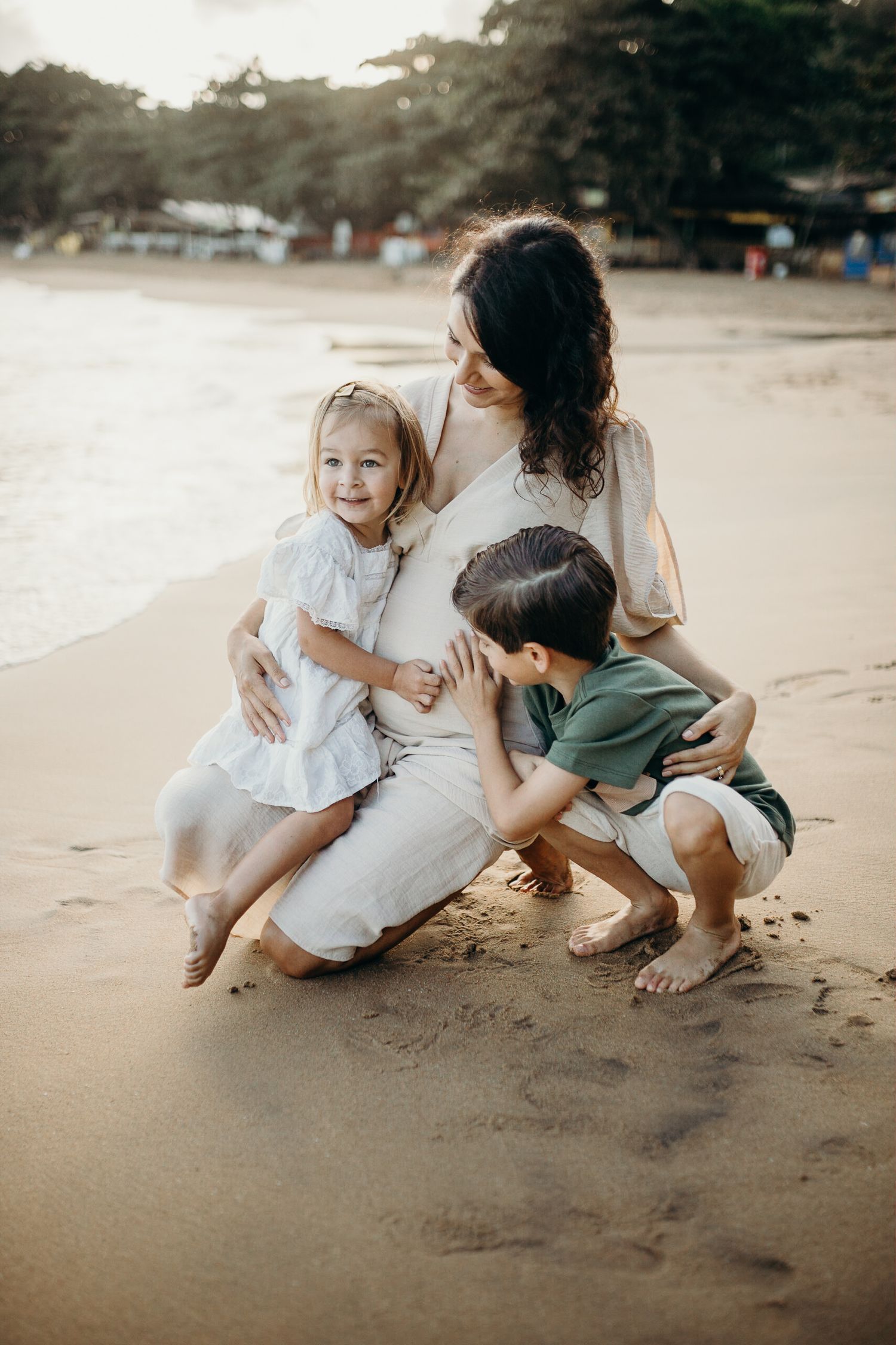 Intimate family beach photoshoot with natural expressions and laughter.