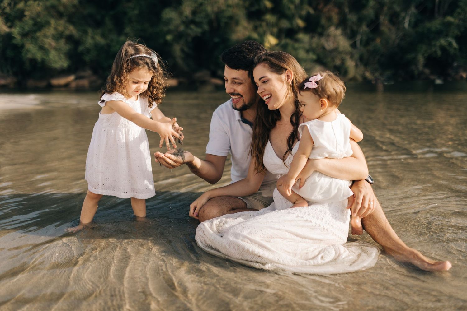 Beautiful lifestyle portrait of family bonding at beach during sunset.