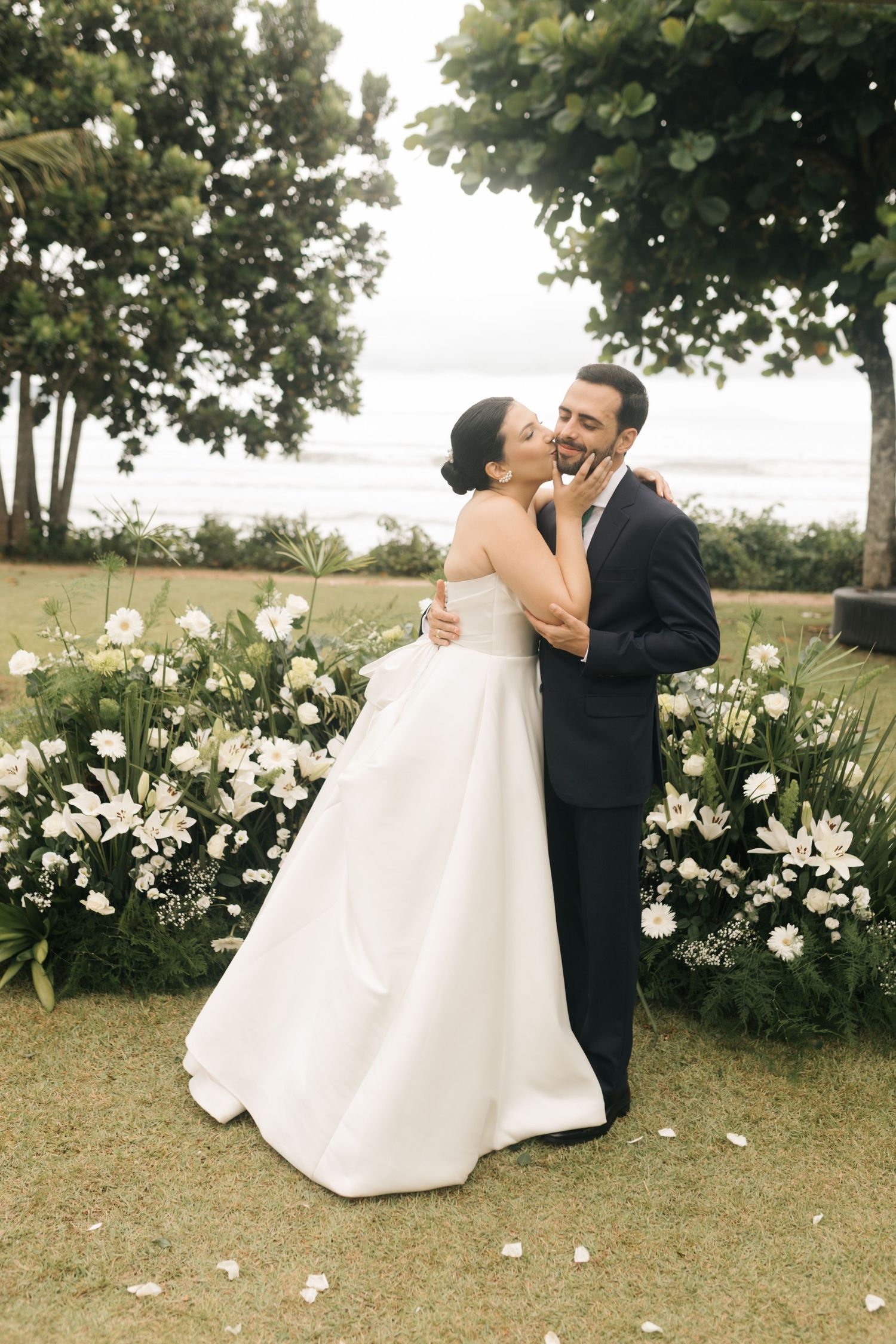 A romantic dance sequence captured in a garden setting with white floral decorations.