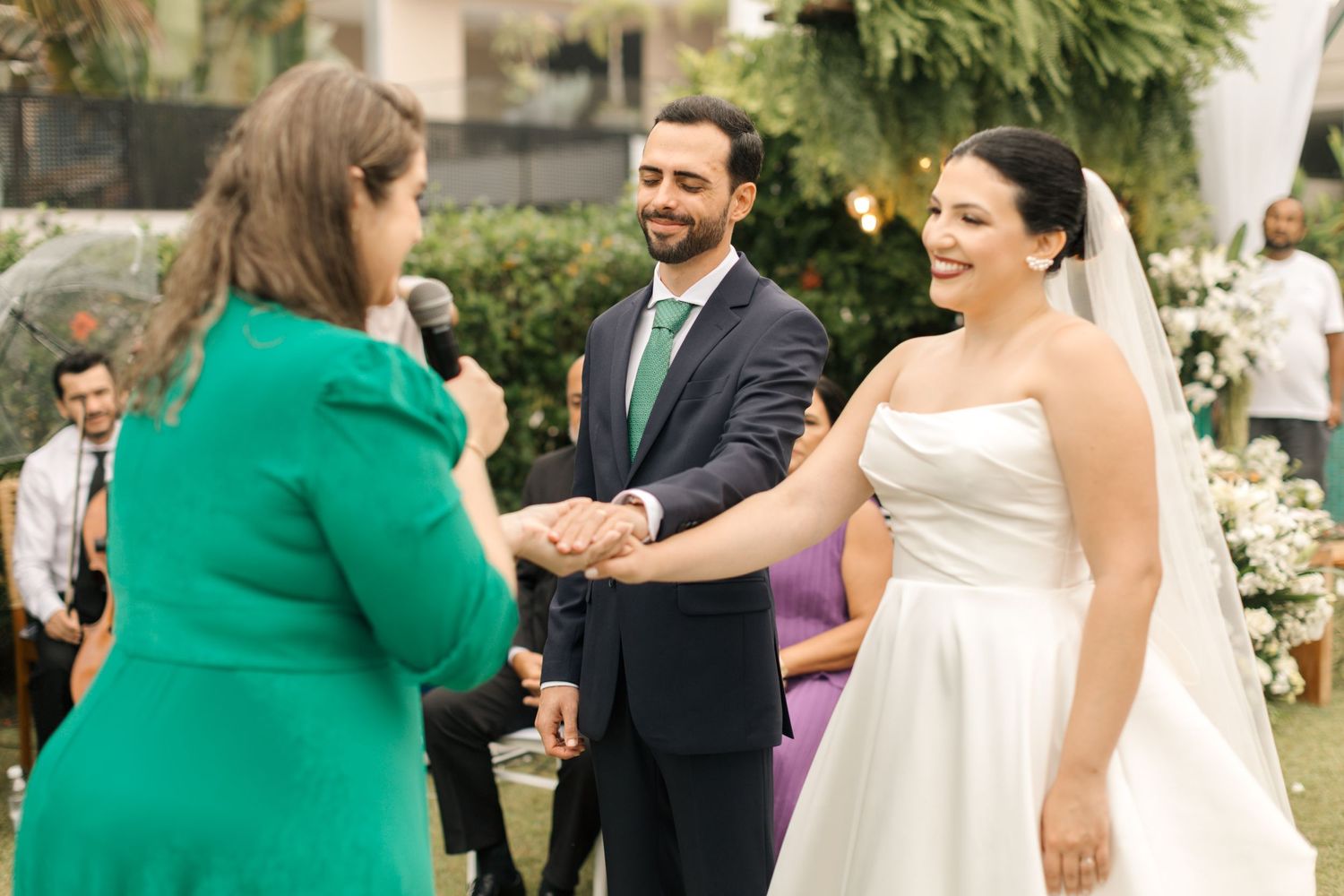 Wedding guests laughing and embracing outdoors during a joyful celebration.