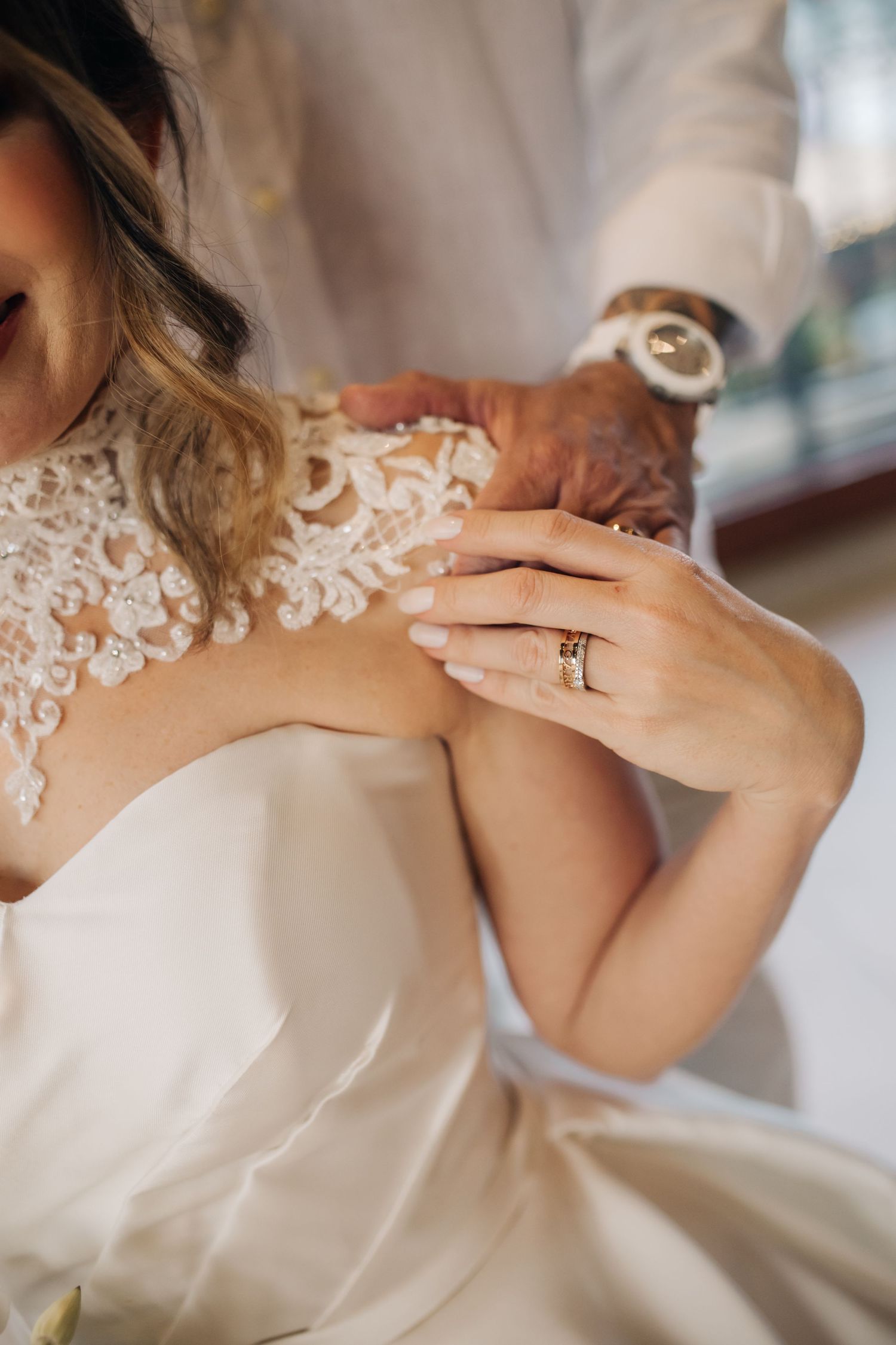 Detail shots of intricate lace wedding dress neckline and jewelry.