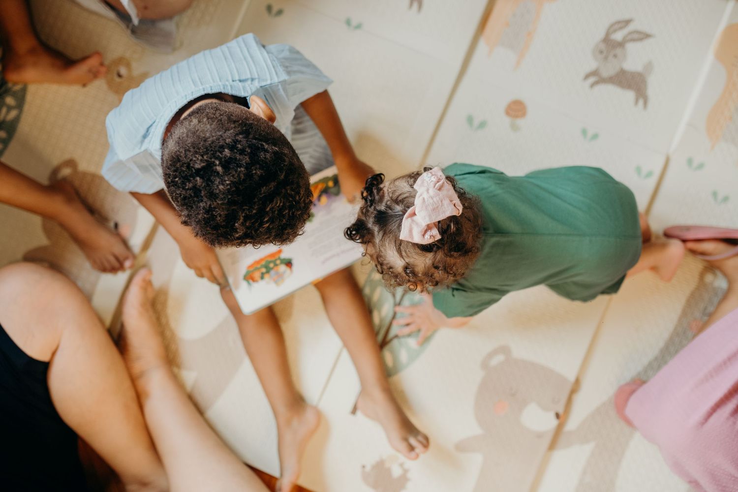 Aerial view of children and adults sitting together during group activity.