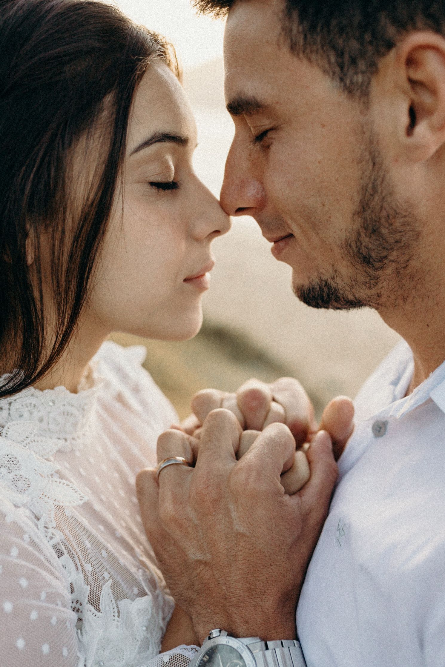 Tender close-up moments between couple in white attire.