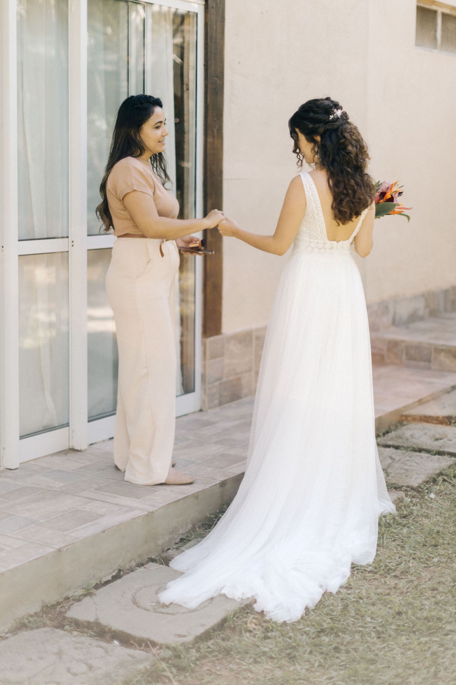 Elegant wedding dress reveal moment outside a building entrance.