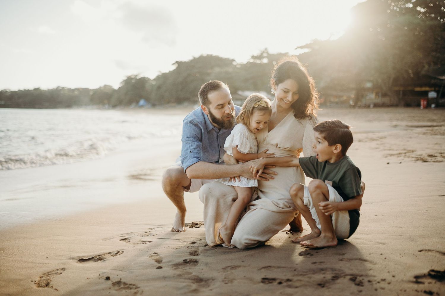 Family enjoying quality time together on sunlit coastal shore.