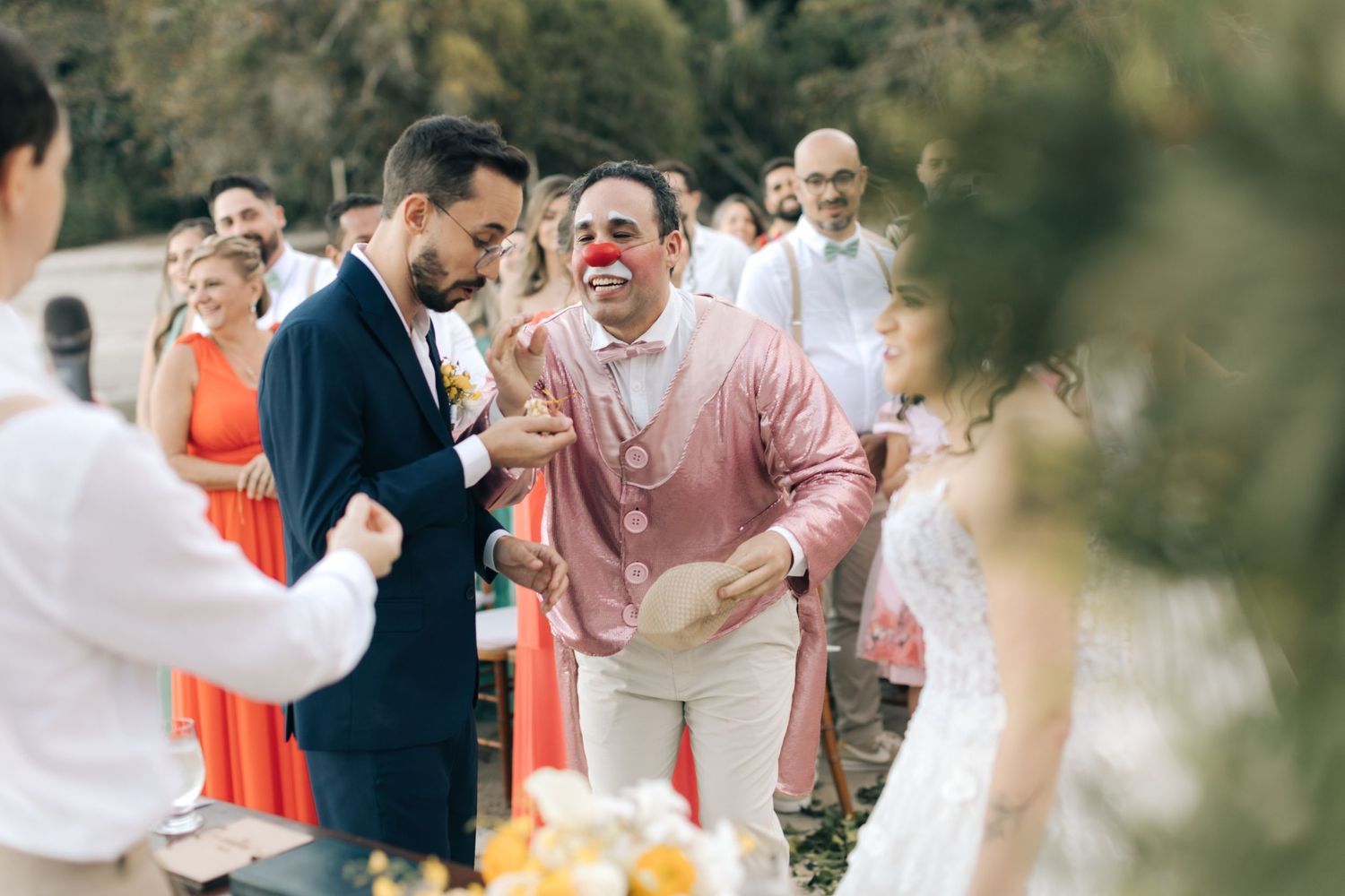 Celebratory moment between wedding guests during outdoor ceremony.