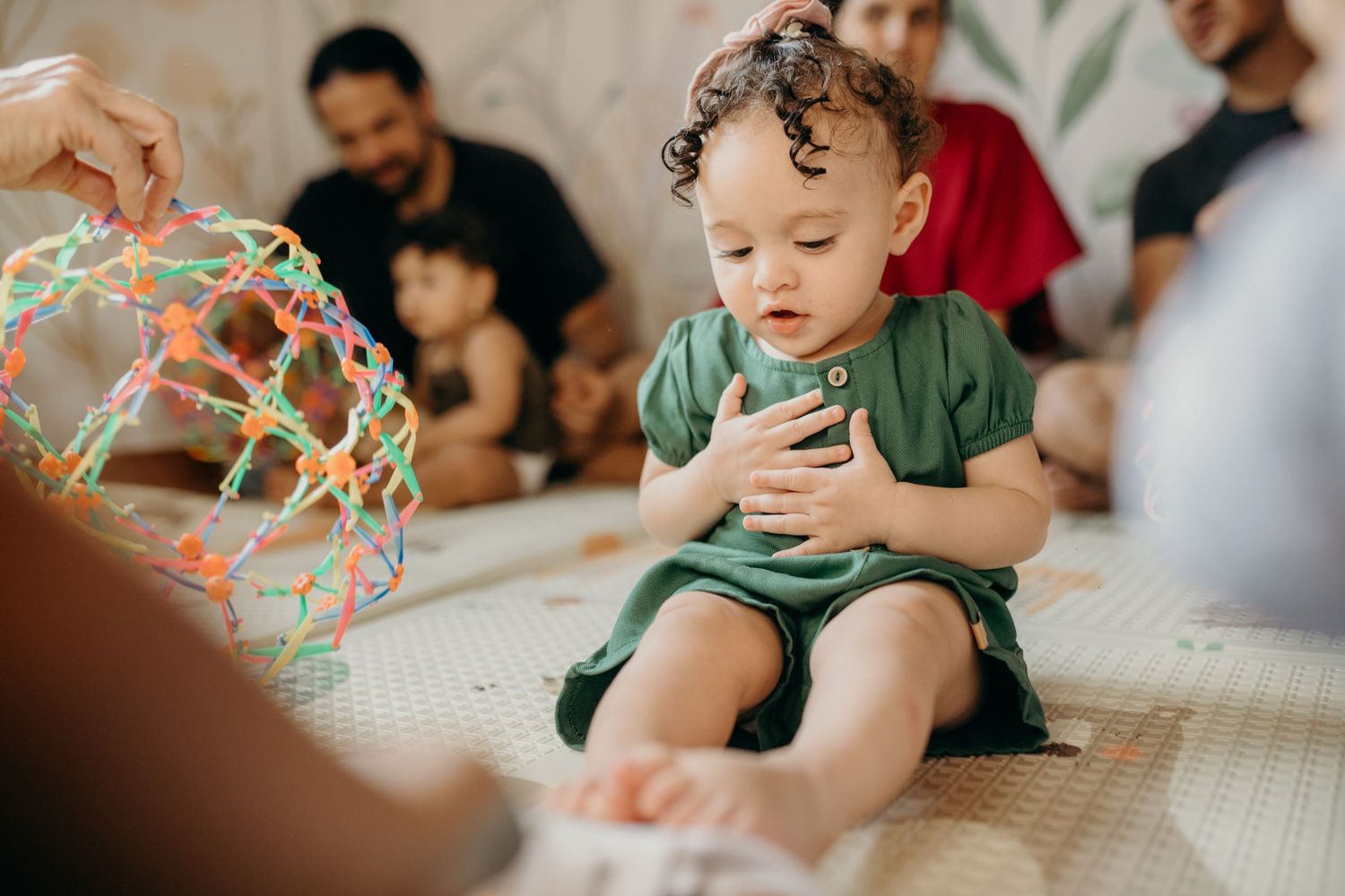 A candid moment of indoor play with toys and family members.
