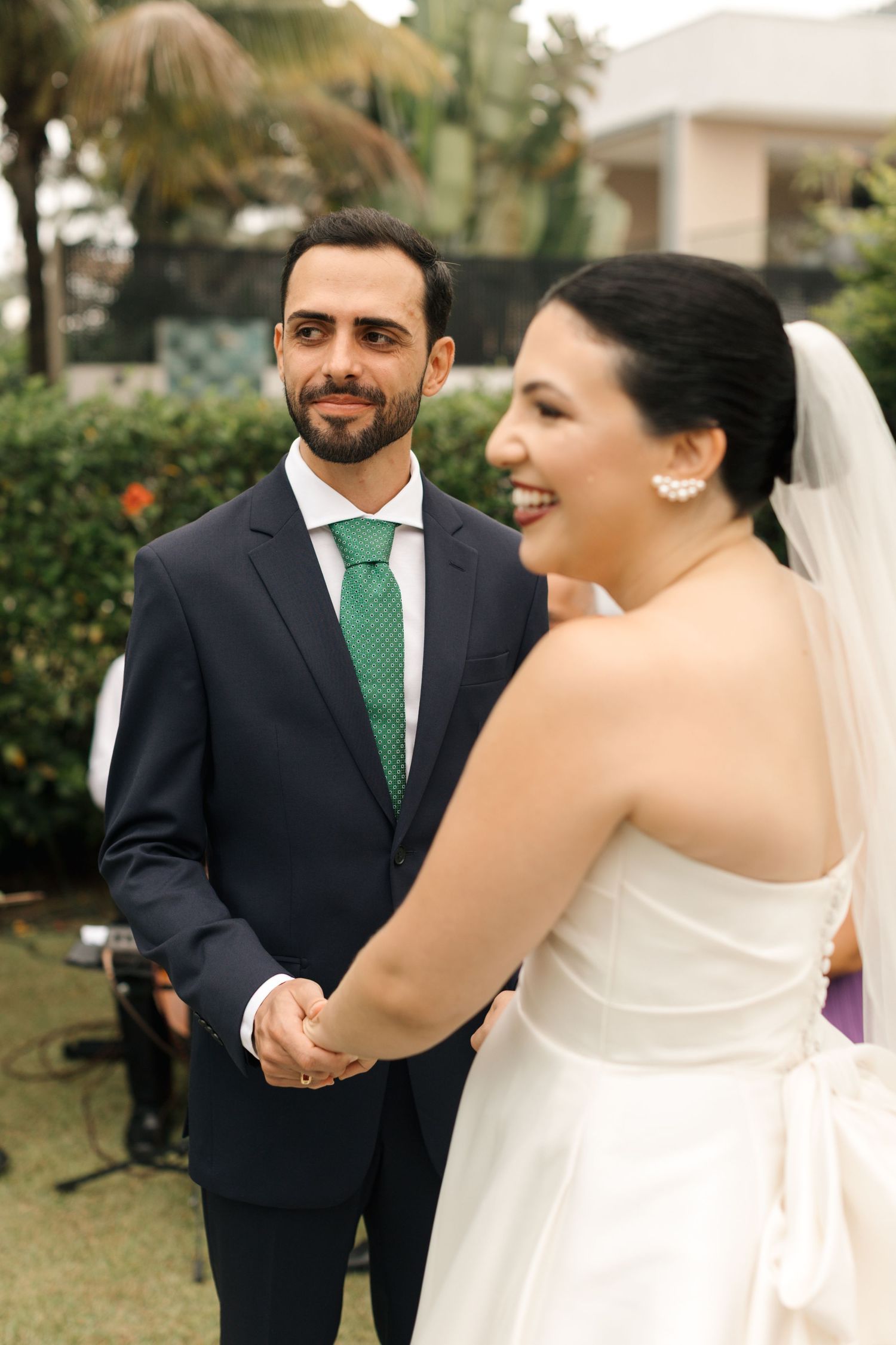 Couple sharing a moment during outdoor garden wedding ceremony.