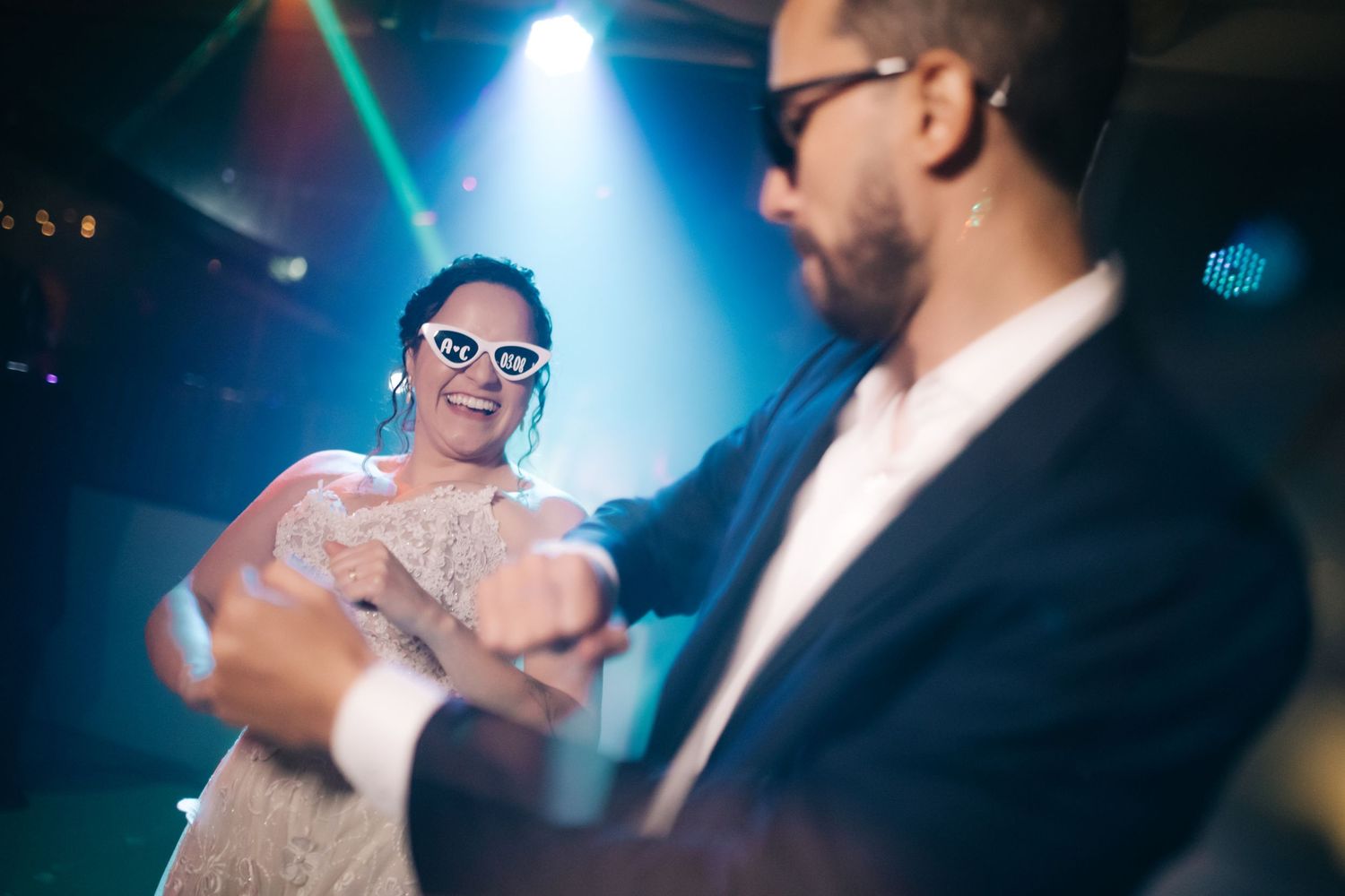 Party scene with blue spotlights and dancing figures in celebratory mood.