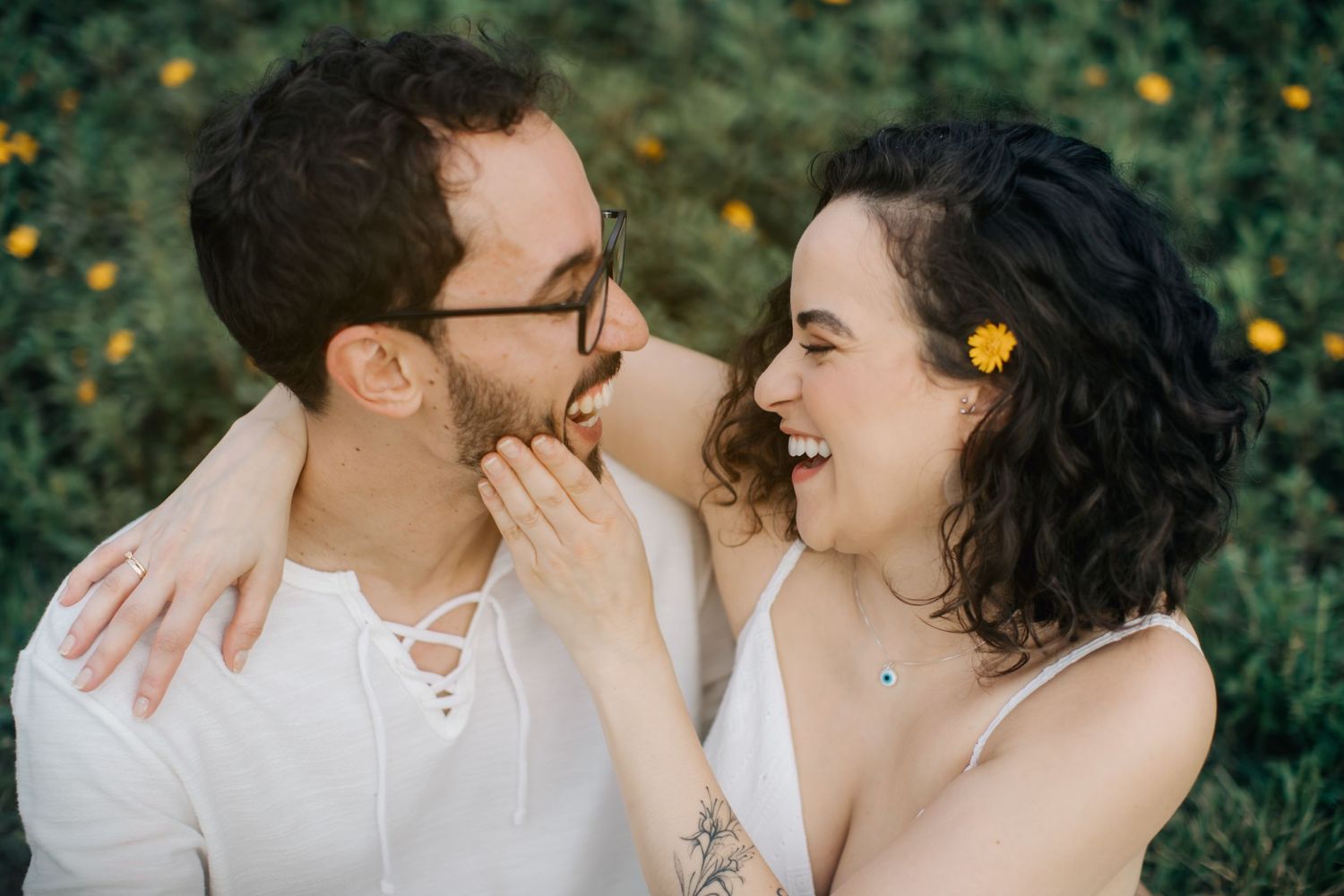 Couple sharing tender moments and laughter during outdoor portrait session.