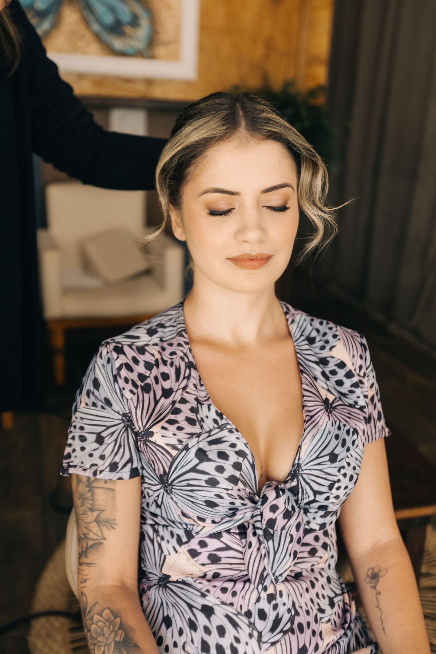 A floral print dress with butterfly pattern is shown in detail with short sleeves and v-neck design.