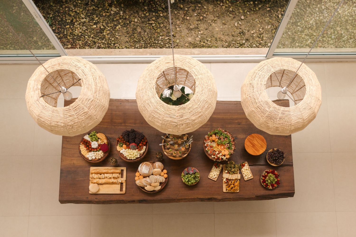 Overhead view of appetizer buffet with paper lanterns and various finger foods.