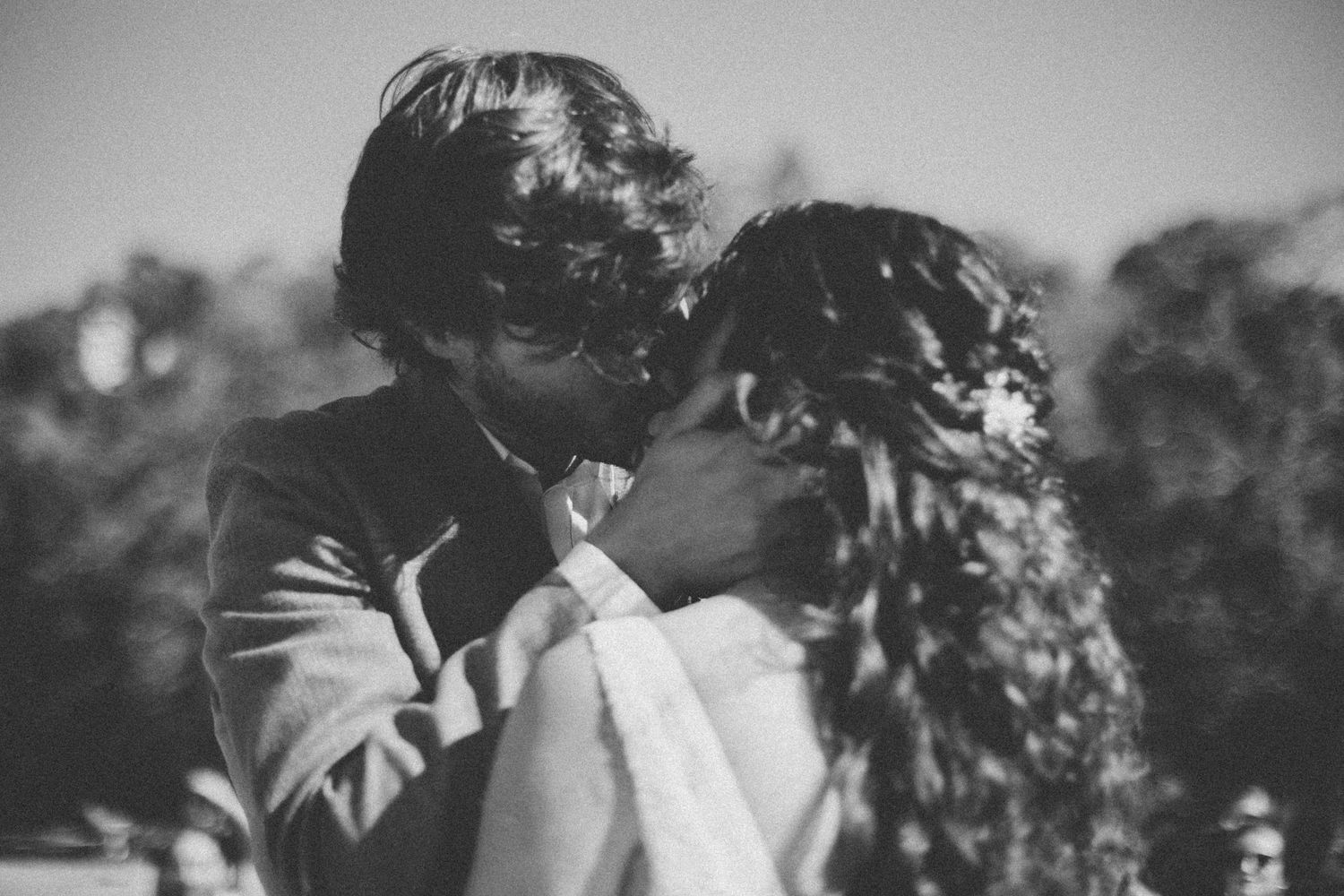 Black and white portrait of couple sharing romantic moment during wedding ceremony.