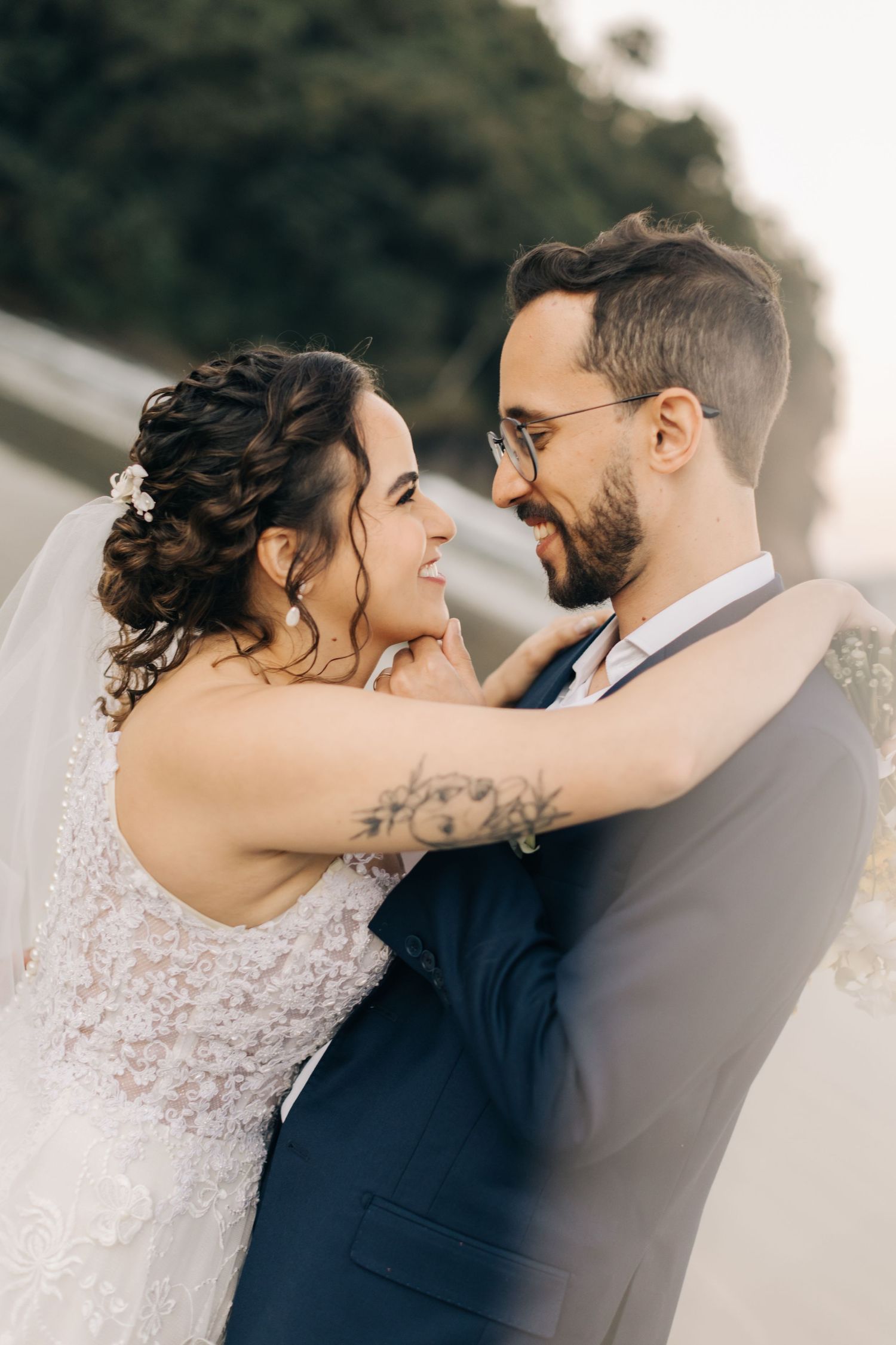 Romantic embrace between newlyweds during their beach wedding photography session.