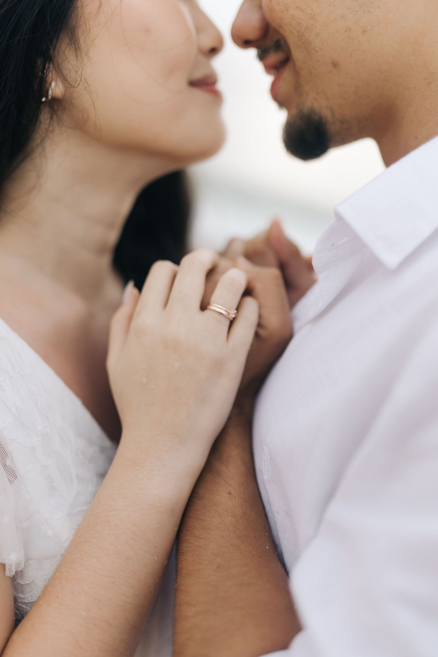 Close-up shots of gentle caresses and romantic gestures between couple.