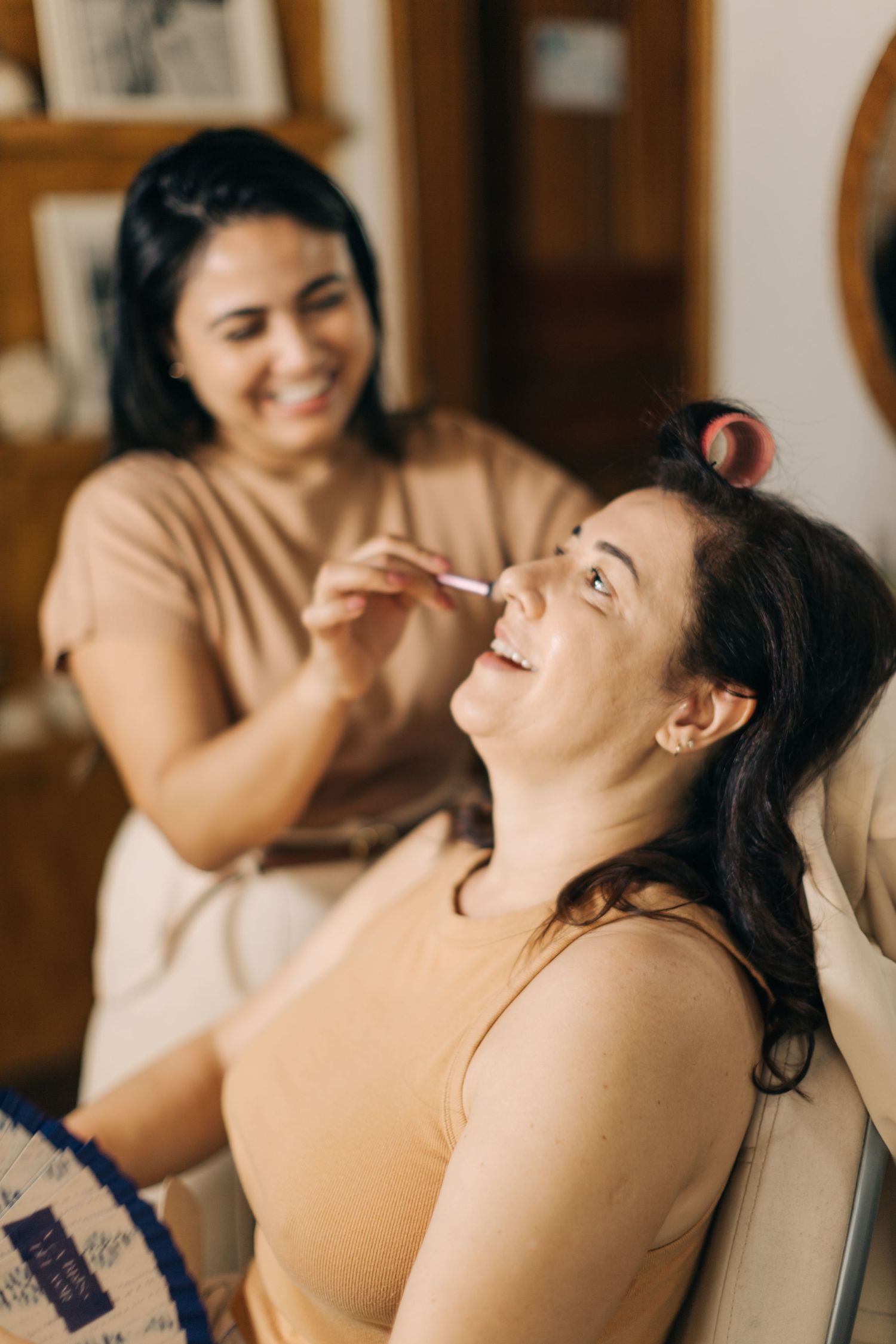 Clients sit in makeup chairs while getting pampered during a beauty session.