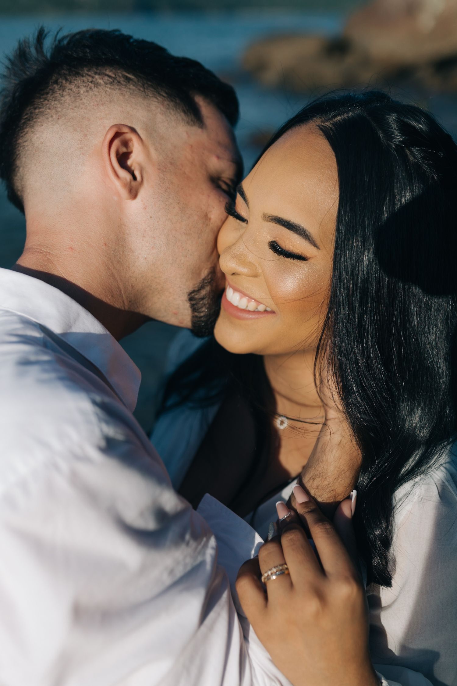 A close-up engagement photo showing an intimate moment between a couple.